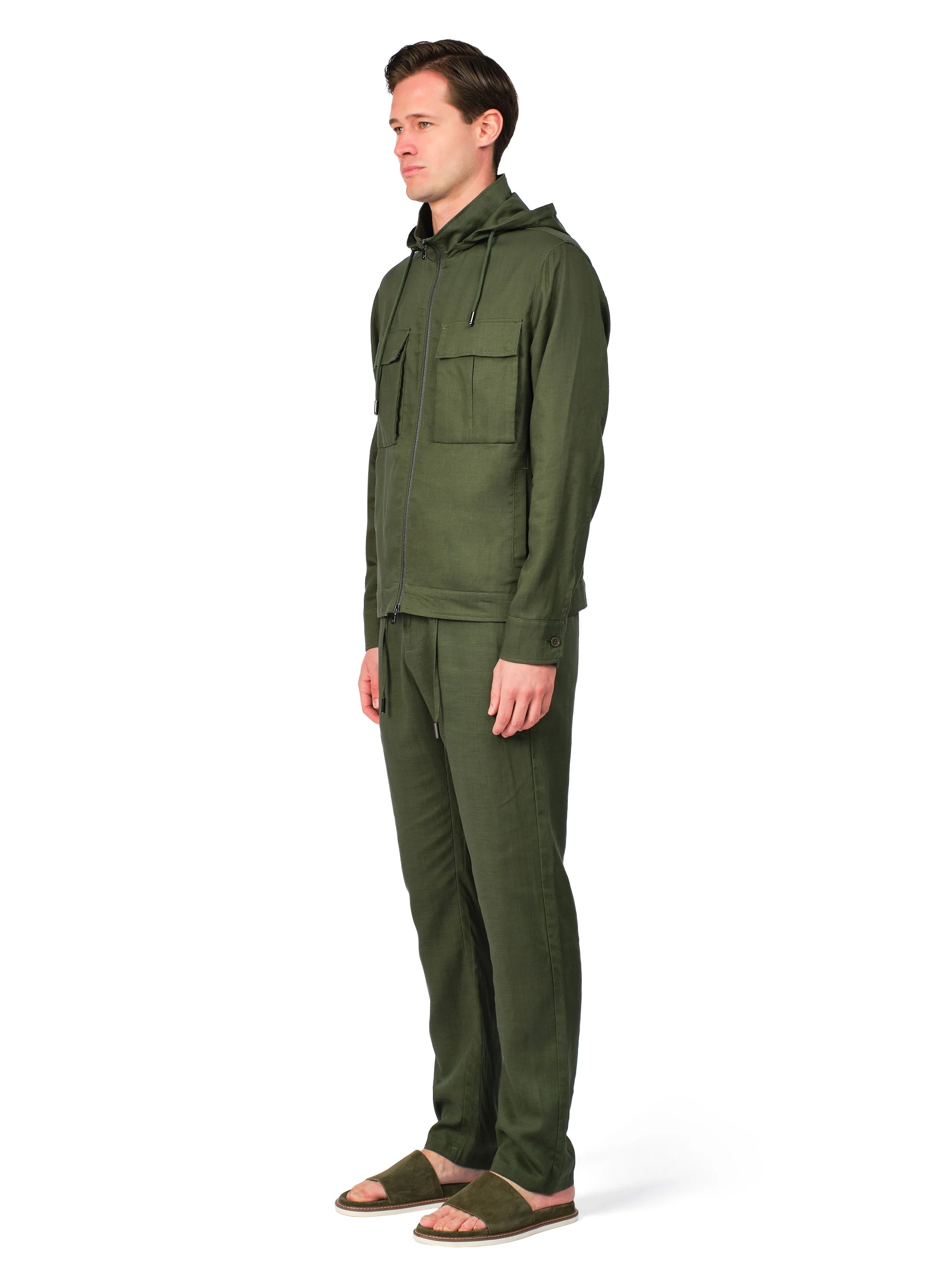 Man wearing a green hooded jacket and pants on a white background