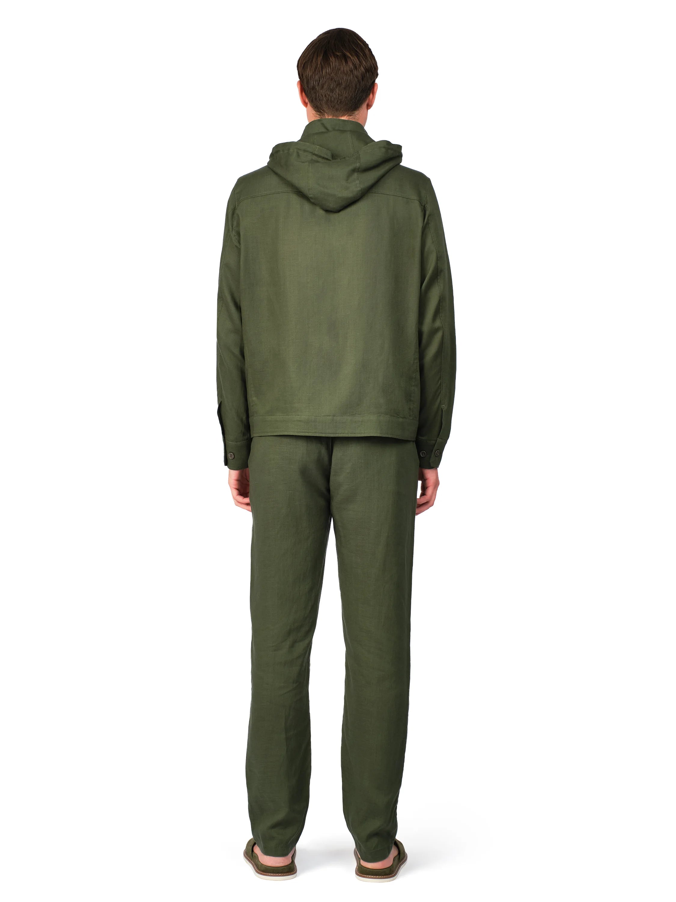 Person wearing a green tracksuit on a white background