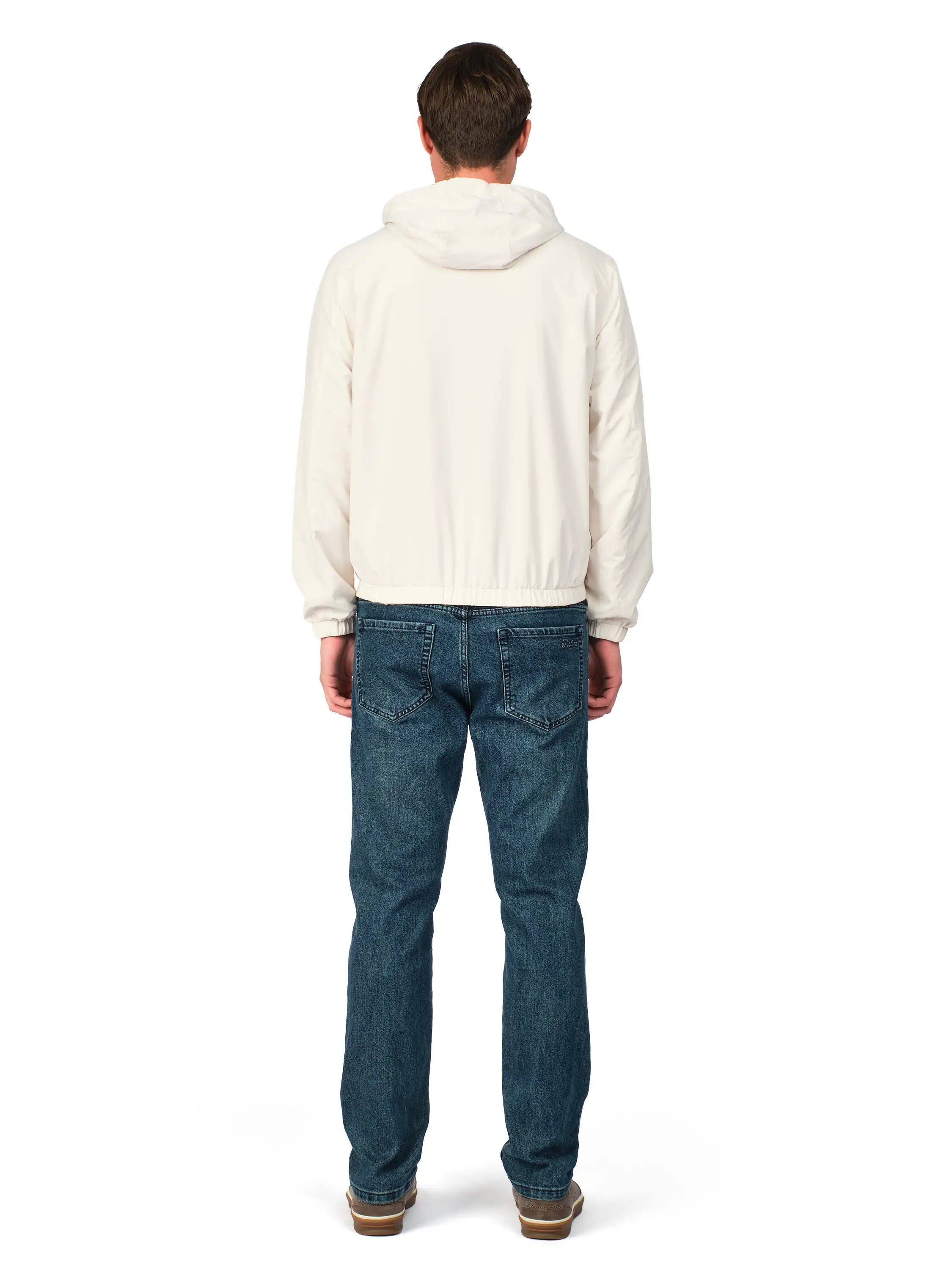 Person wearing a white hoodie and blue jeans on a white background
