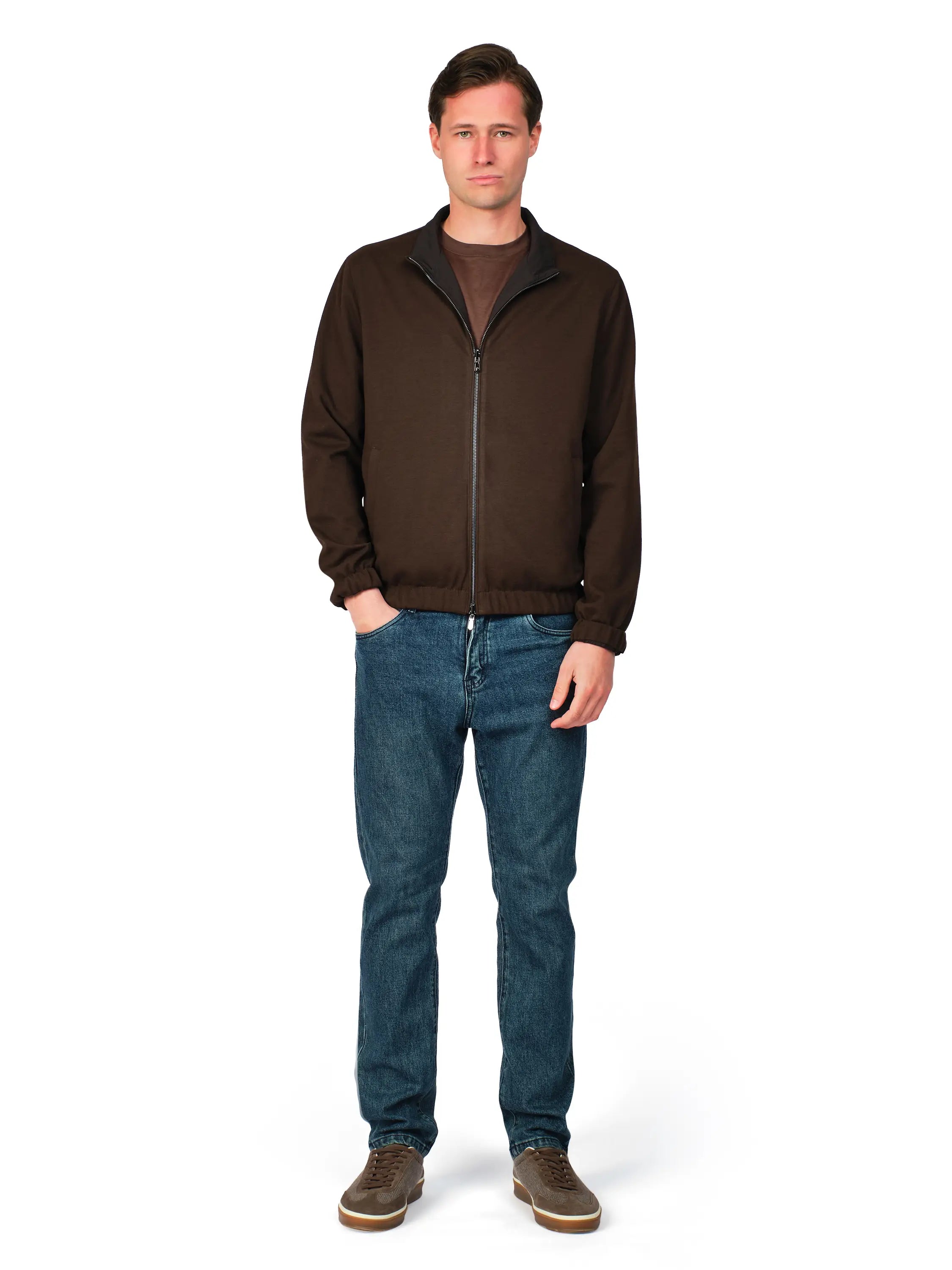 Man wearing a brown jacket and blue jeans on a white background