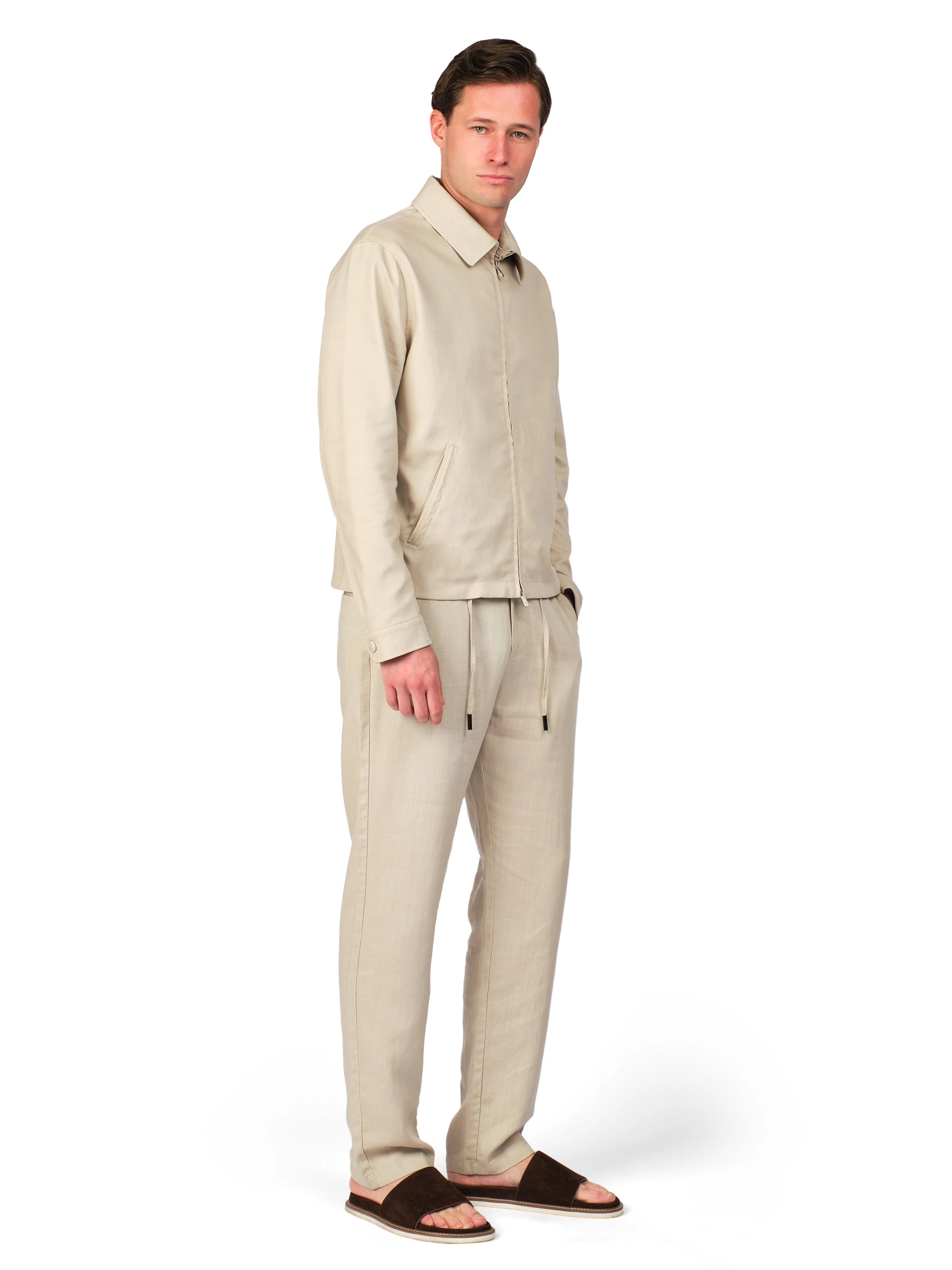Man wearing a beige outfit on a white background