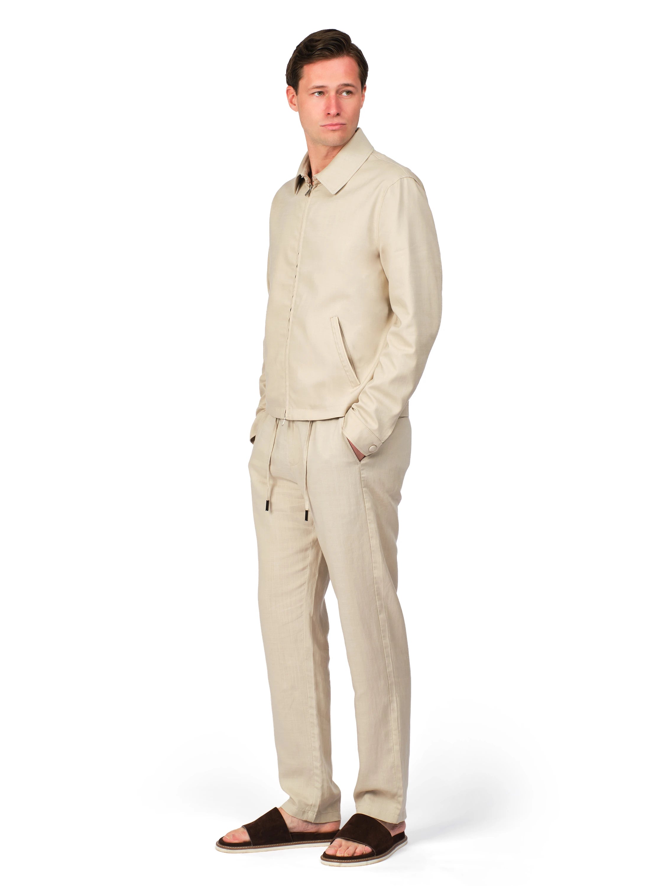 Man wearing a beige linen suit on a white background