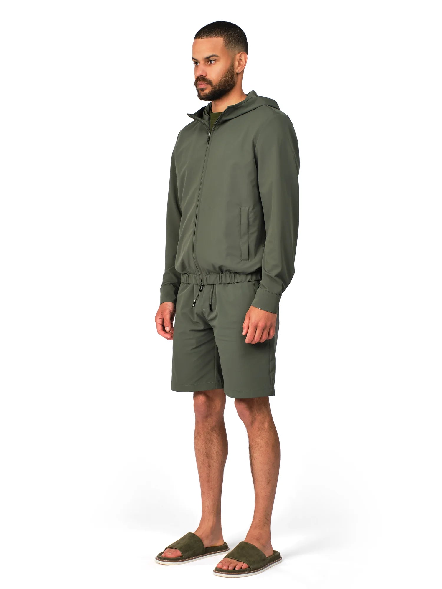 Man wearing a green tracksuit on a white background