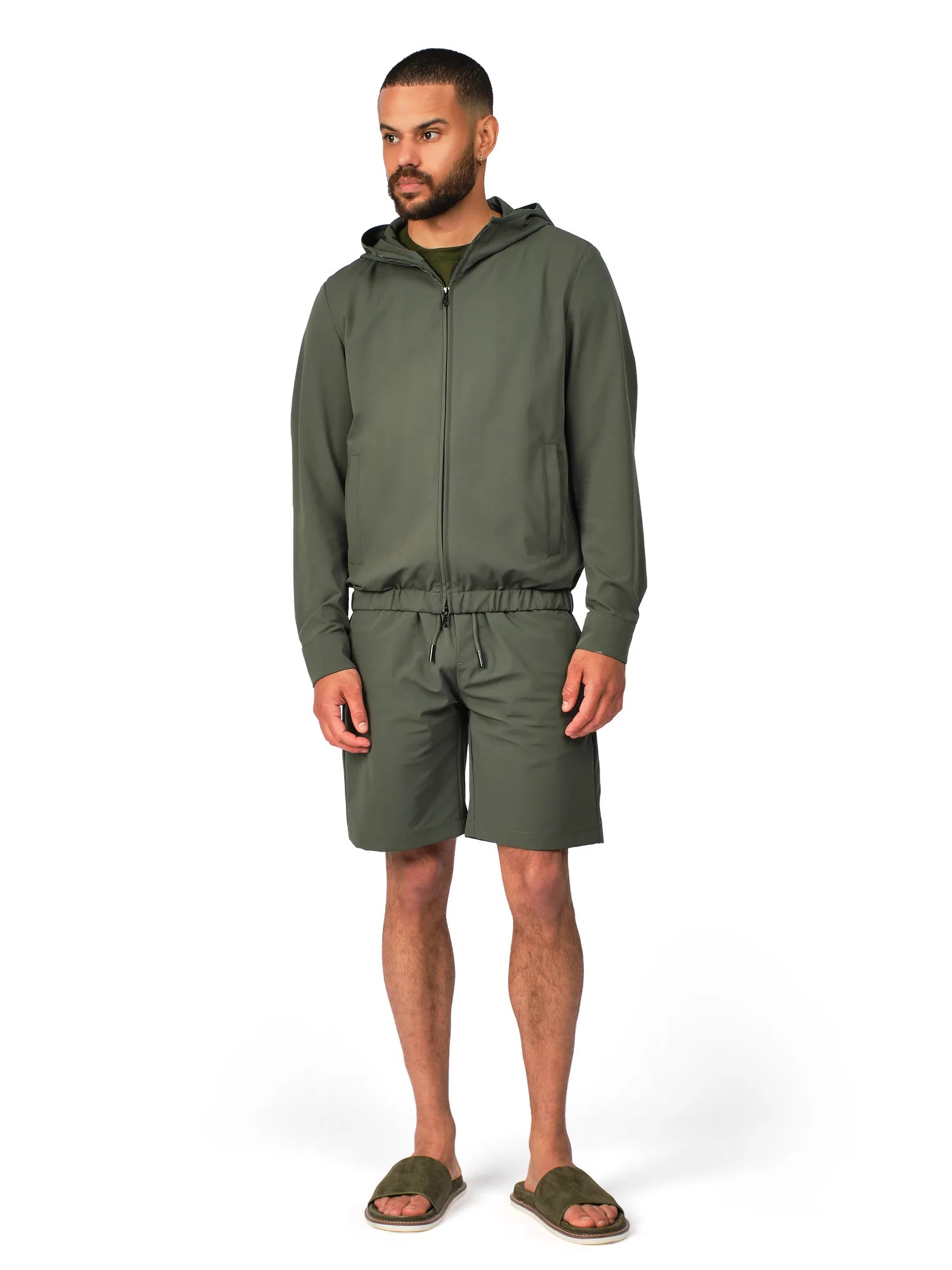 Man wearing a green tracksuit on a white background