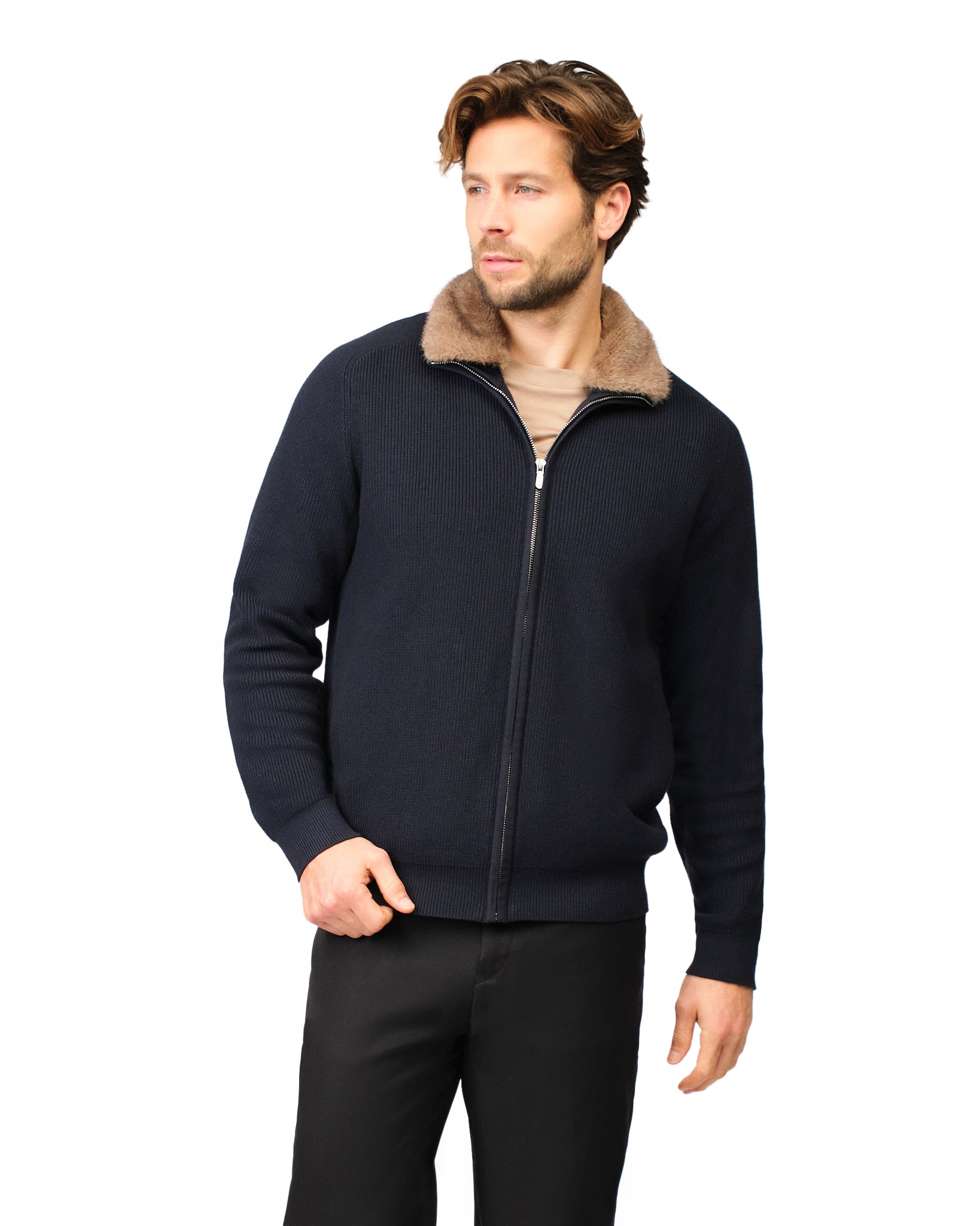 Man wearing a navy blue jacket with a fur-lined hood on a white background