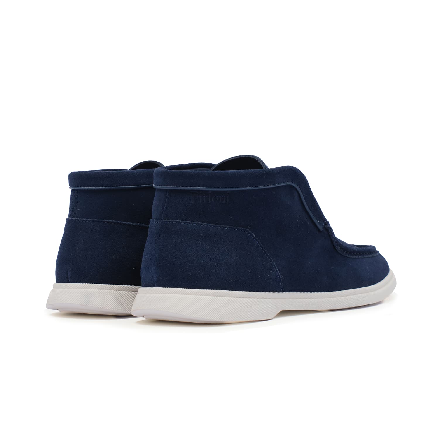 Pair of navy blue shoes with white soles on a white background