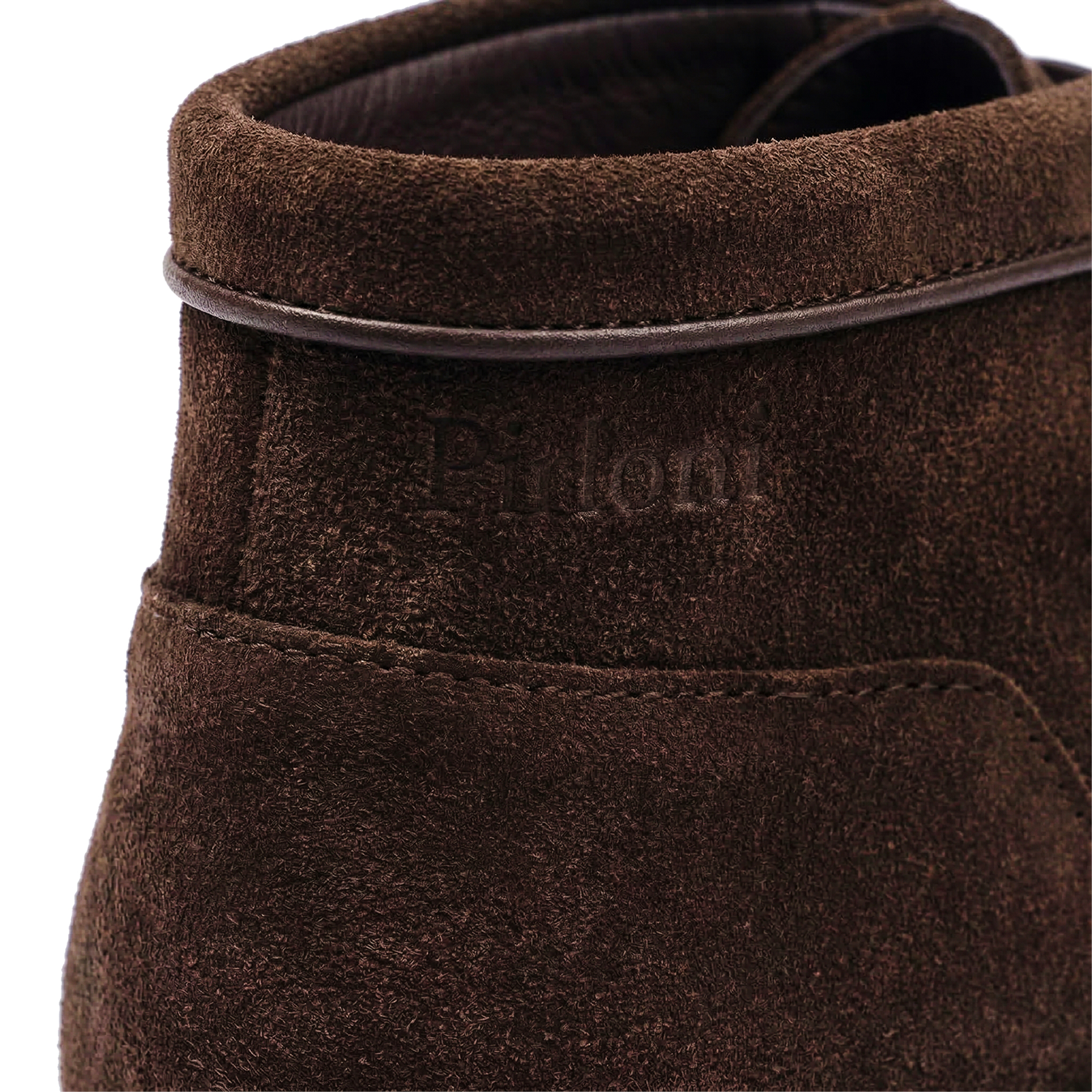 Close-up of a brown suede shoe with 'Talon' branding on a white background