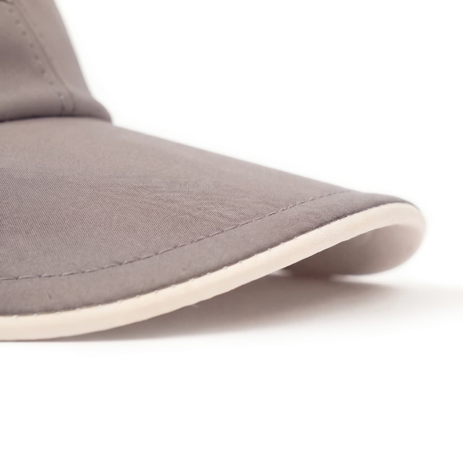 Close-up of a gray shoe with a white sole on a light background