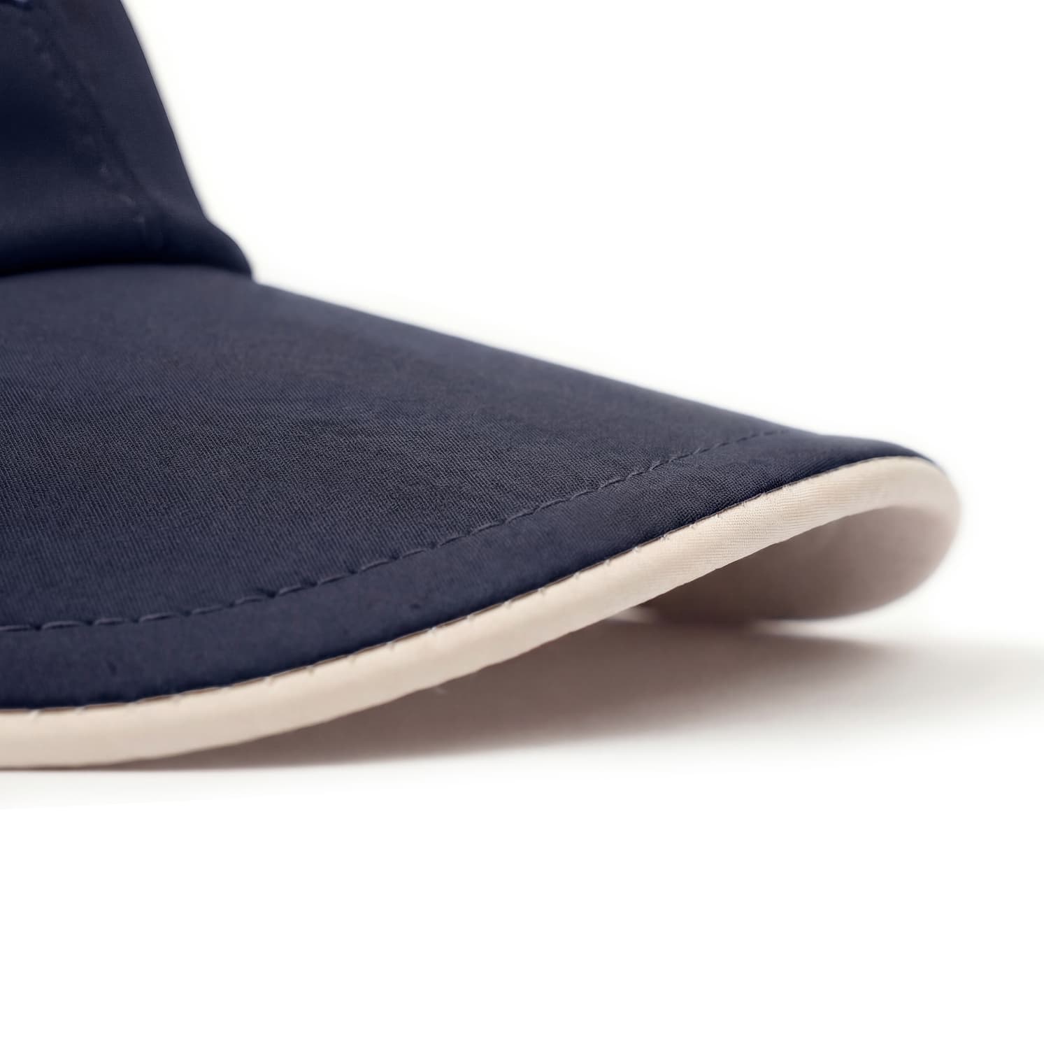Navy blue shoe with a white sole on a light gray background