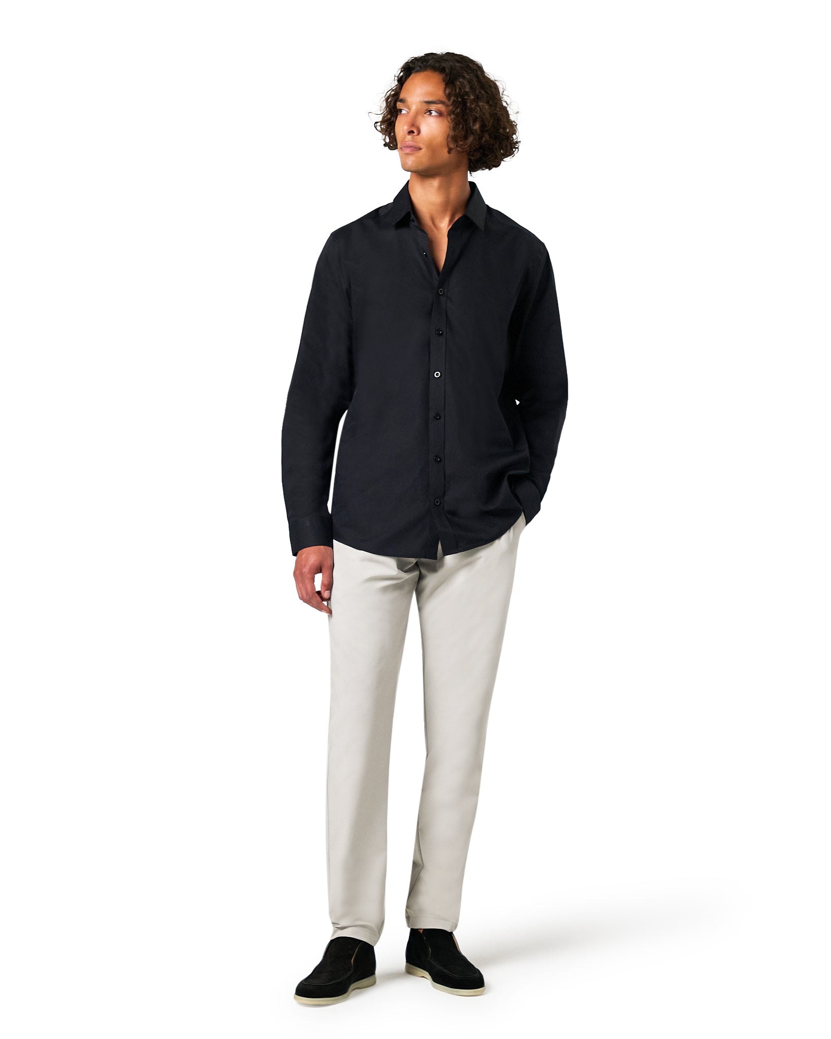 Man wearing a black shirt and white pants