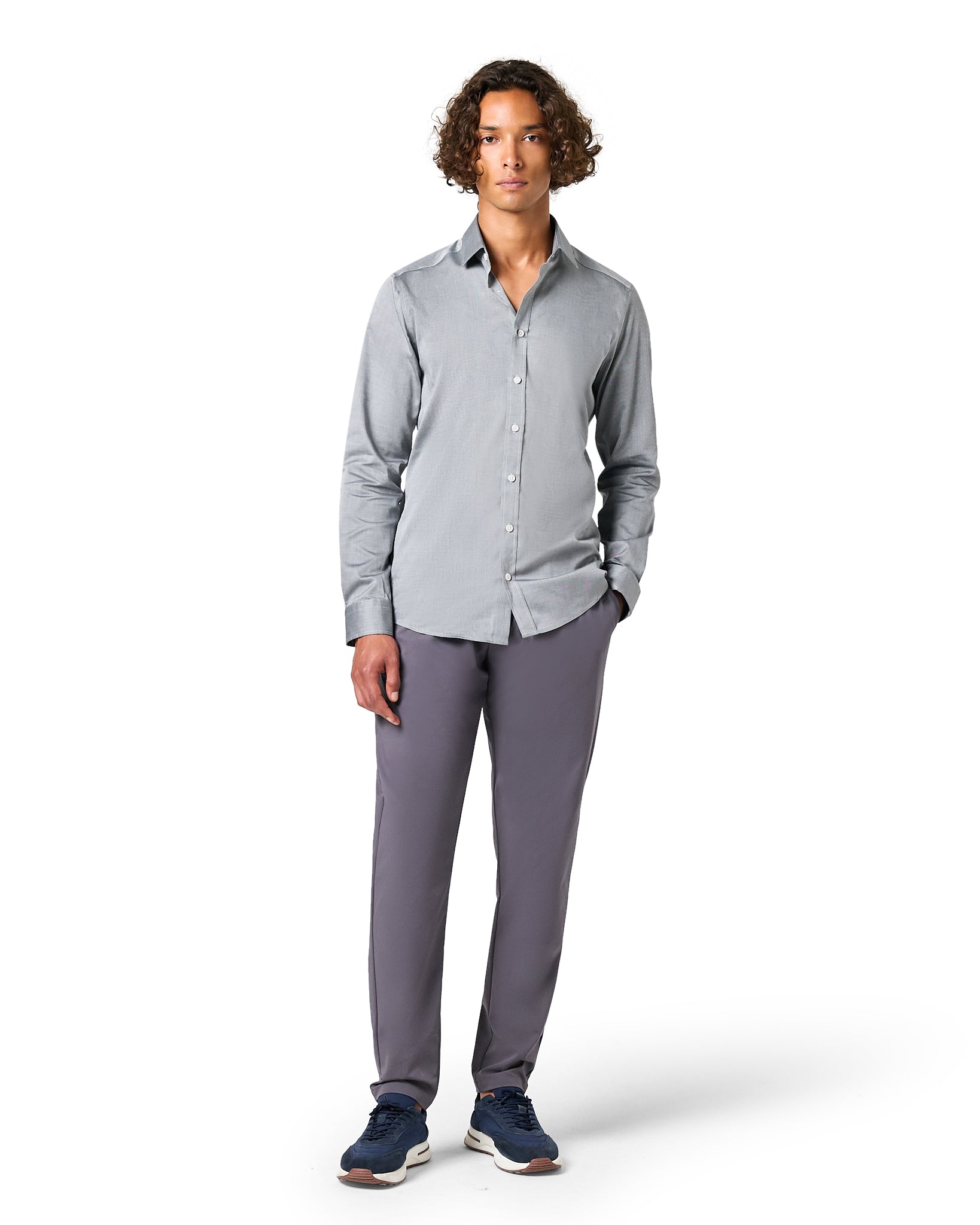 Man wearing a gray button-up shirt and pants