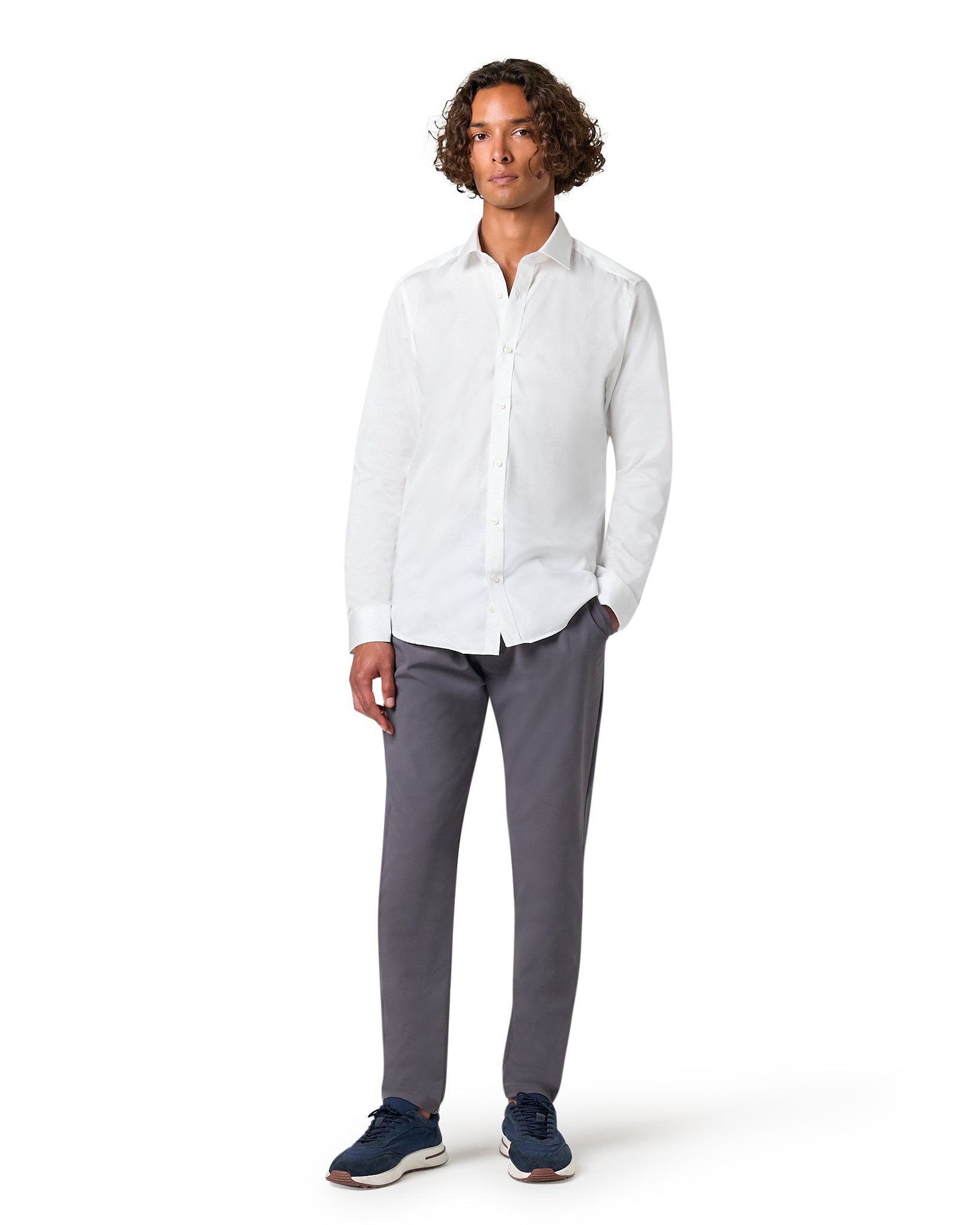 Man wearing a white shirt and gray pants