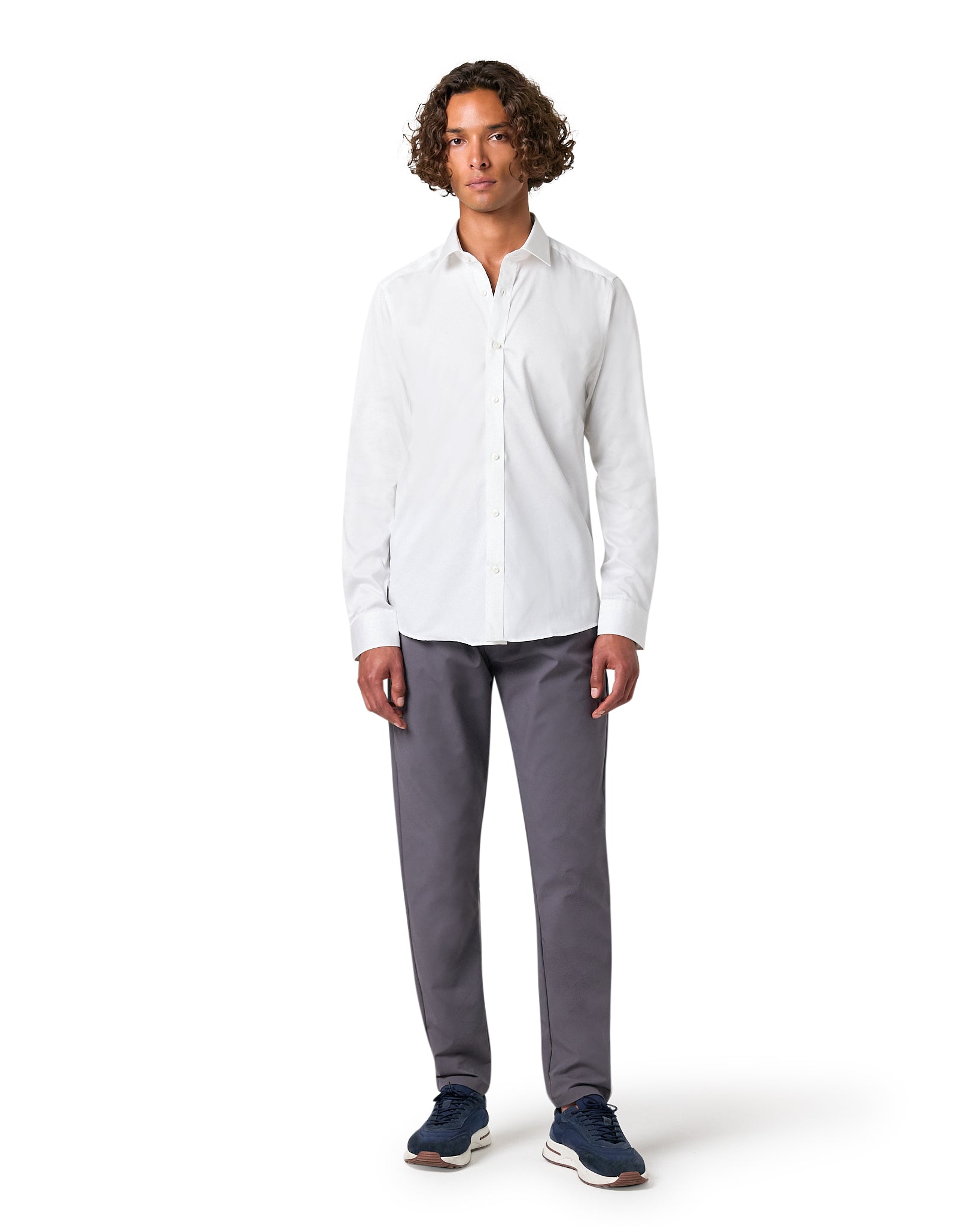 Man wearing a white shirt and gray pants