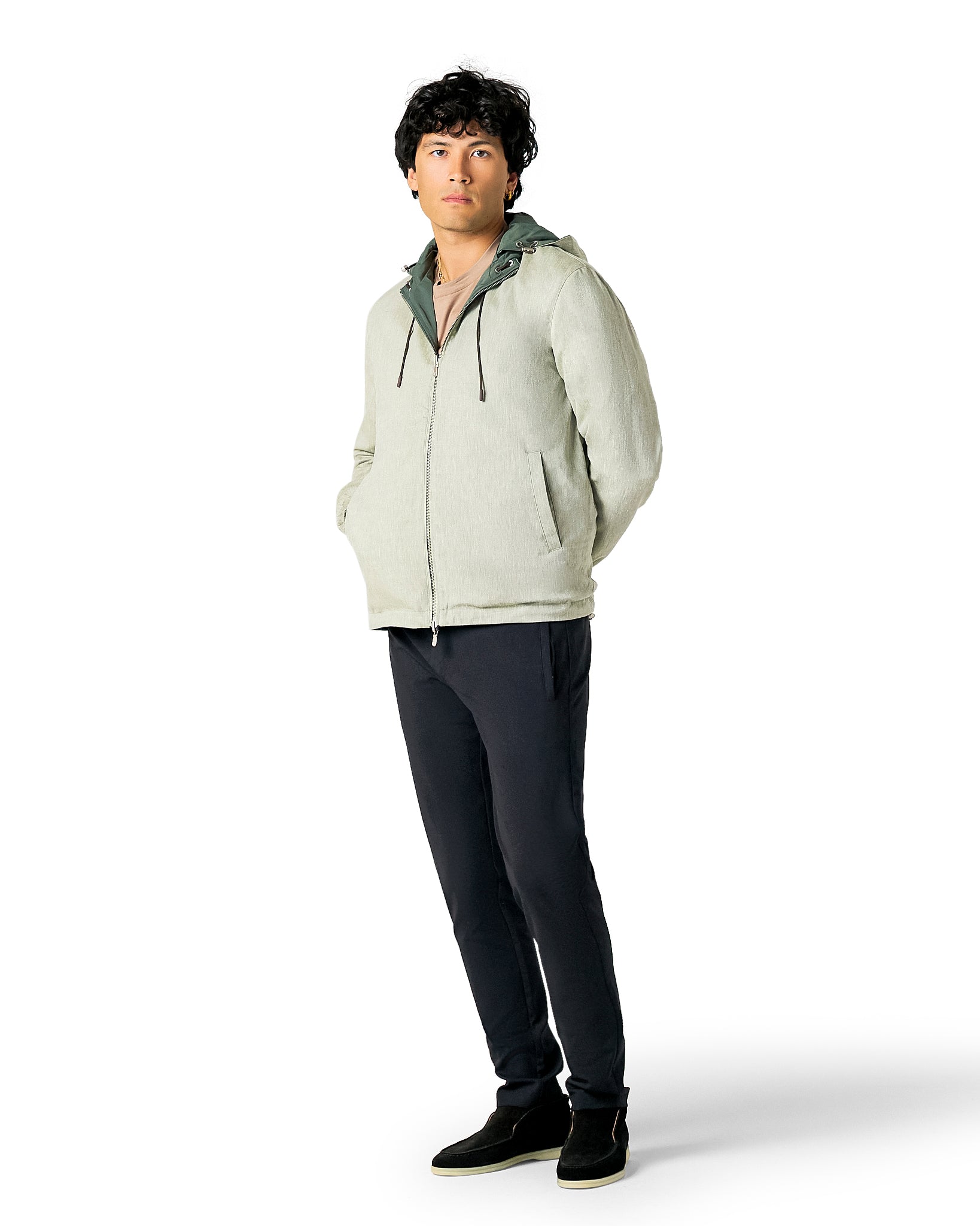 Man wearing a light gray hoodie and dark pants