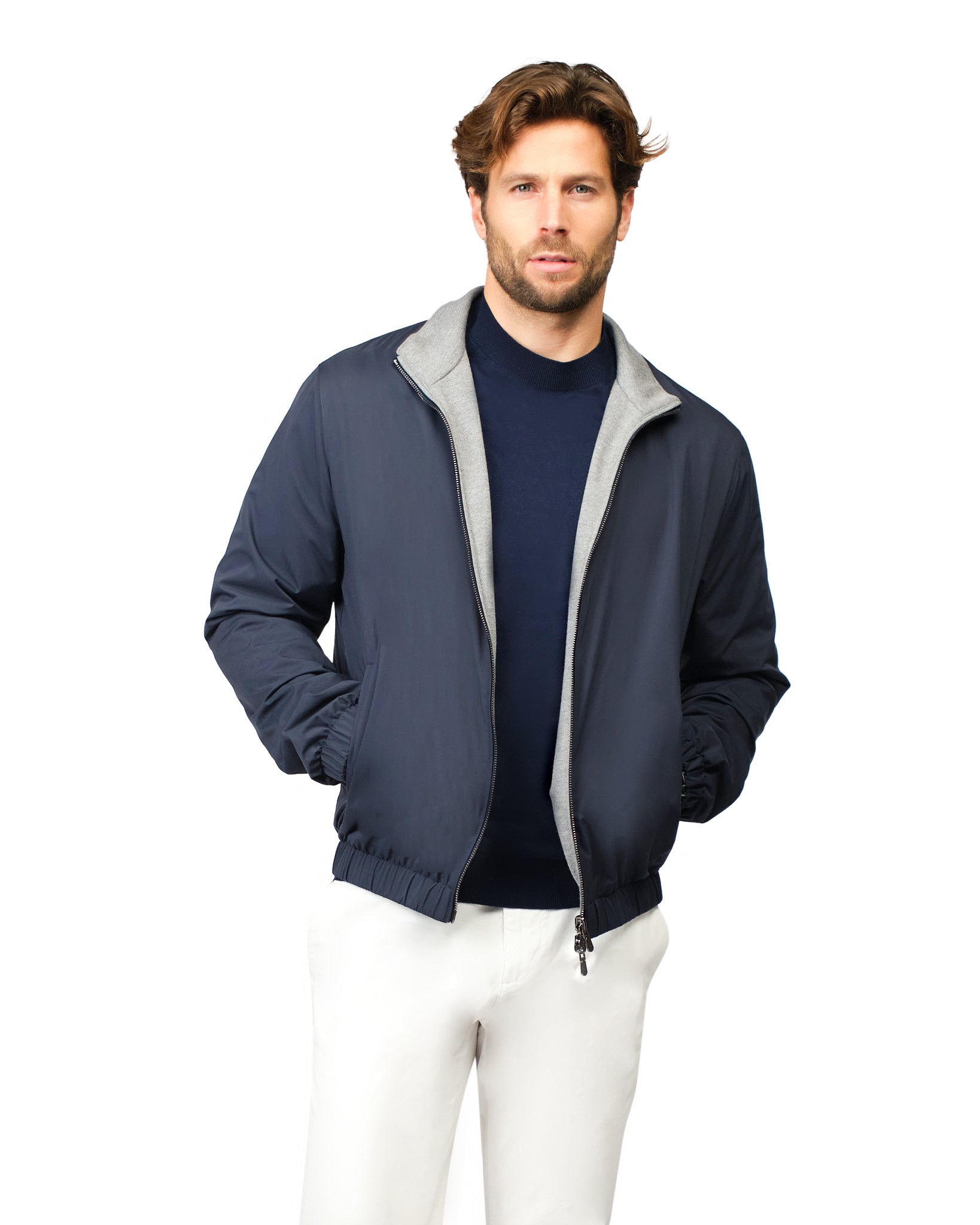 Man wearing a navy jacket with gray lining on a white background