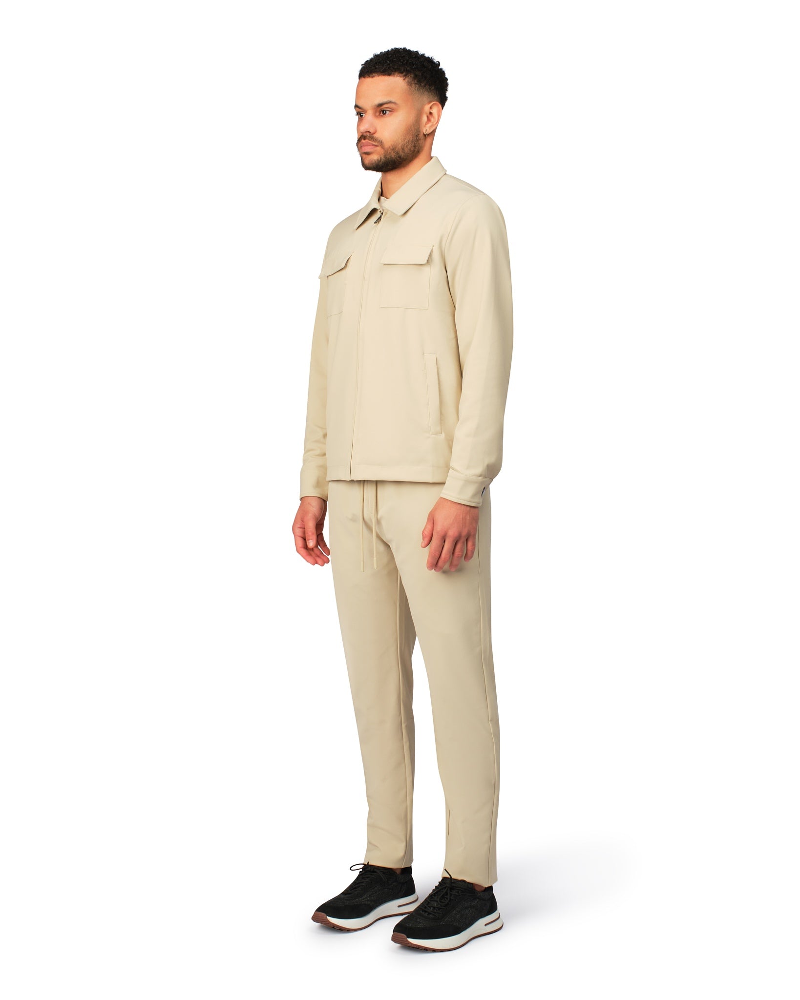 Man wearing a beige suit on a white background