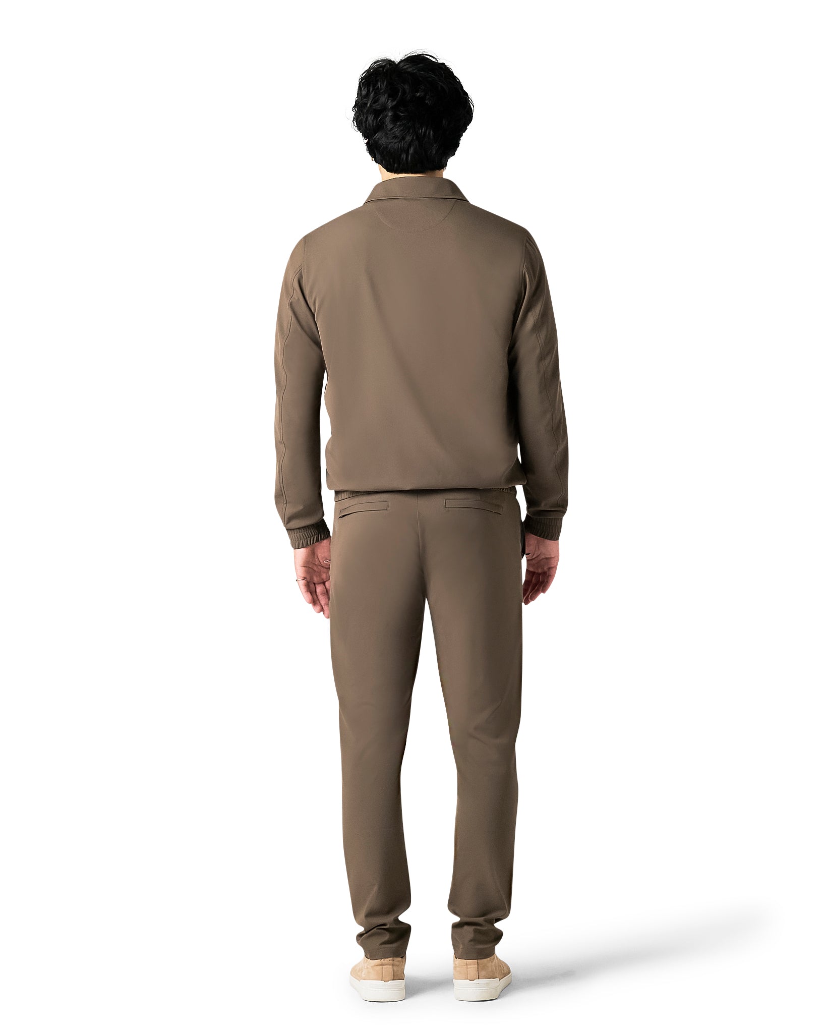 Person wearing a brown outfit on a white background
