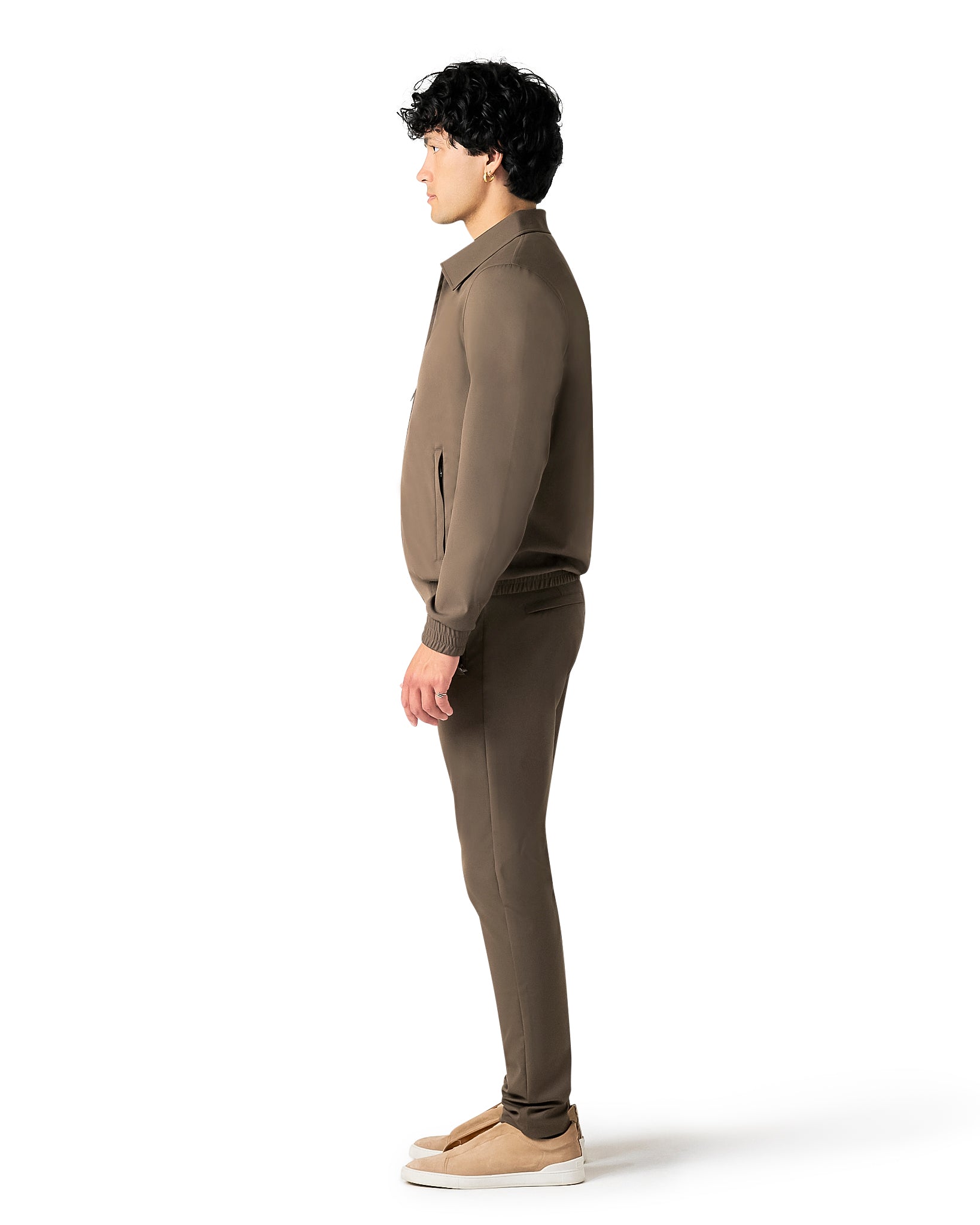 Person wearing a brown outfit on a white background