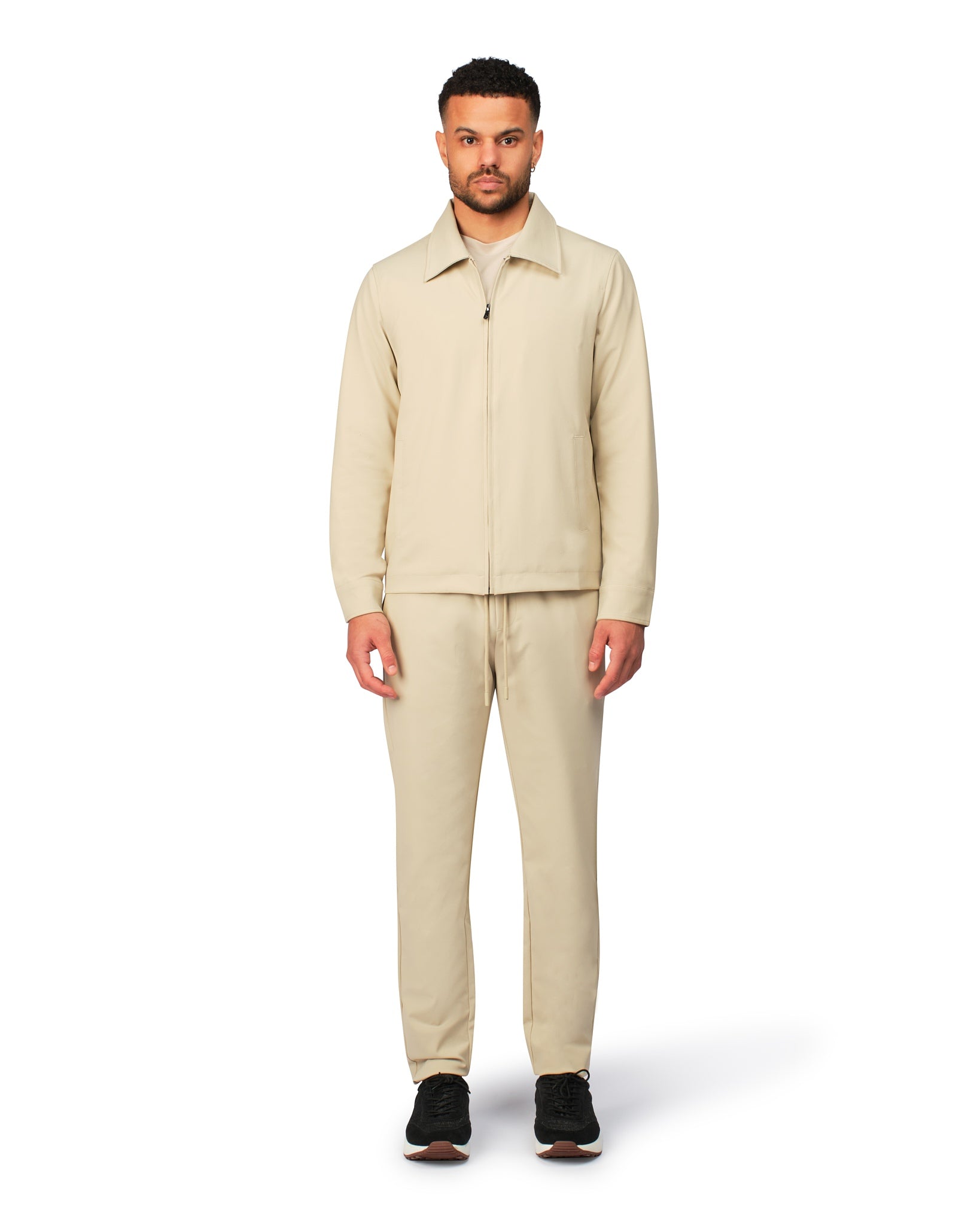 Beige tech jacket with sleek design and zip closure, angled product view showing fit and details.