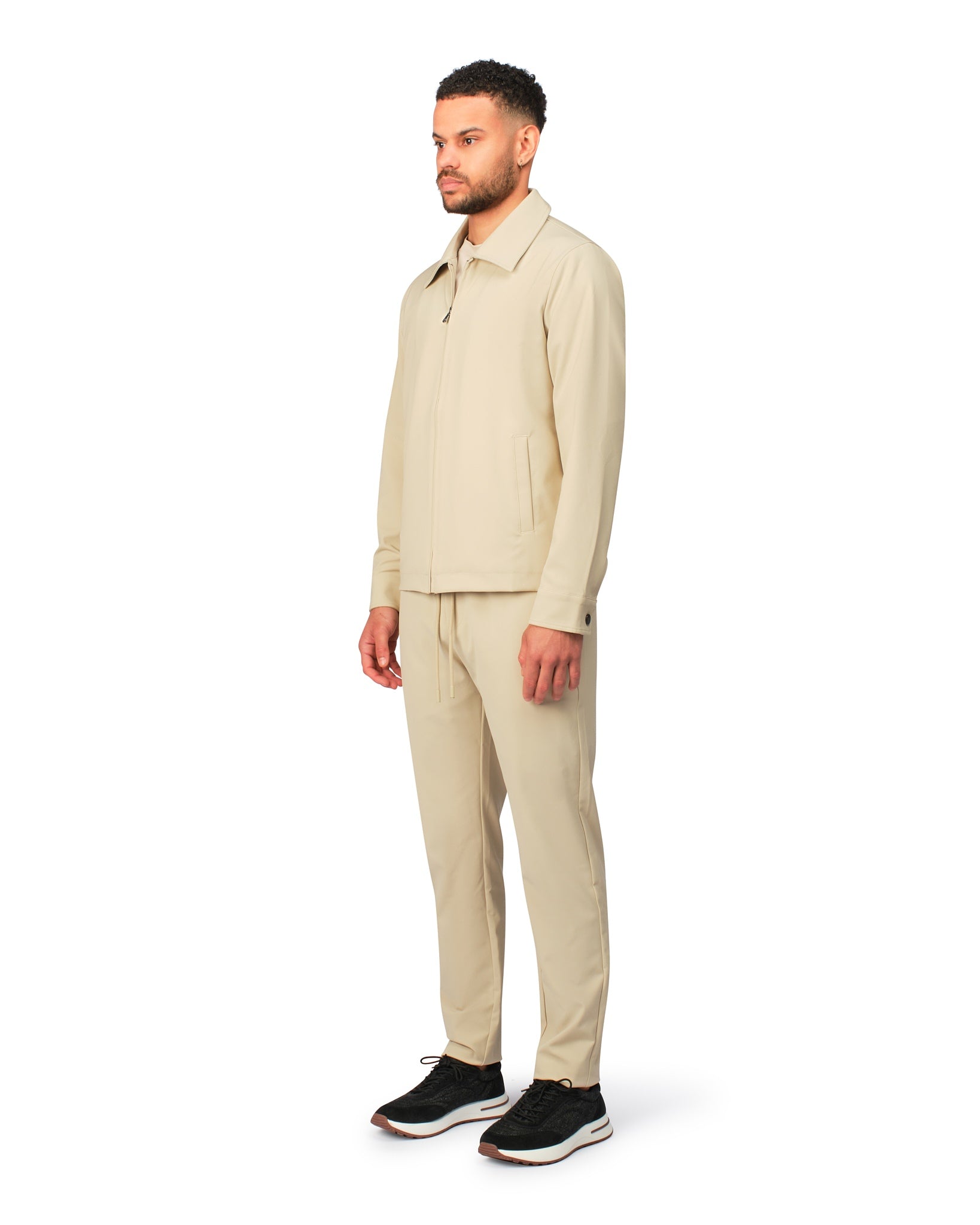 Beige tech jacket with modern design and front zipper, detailed product view.