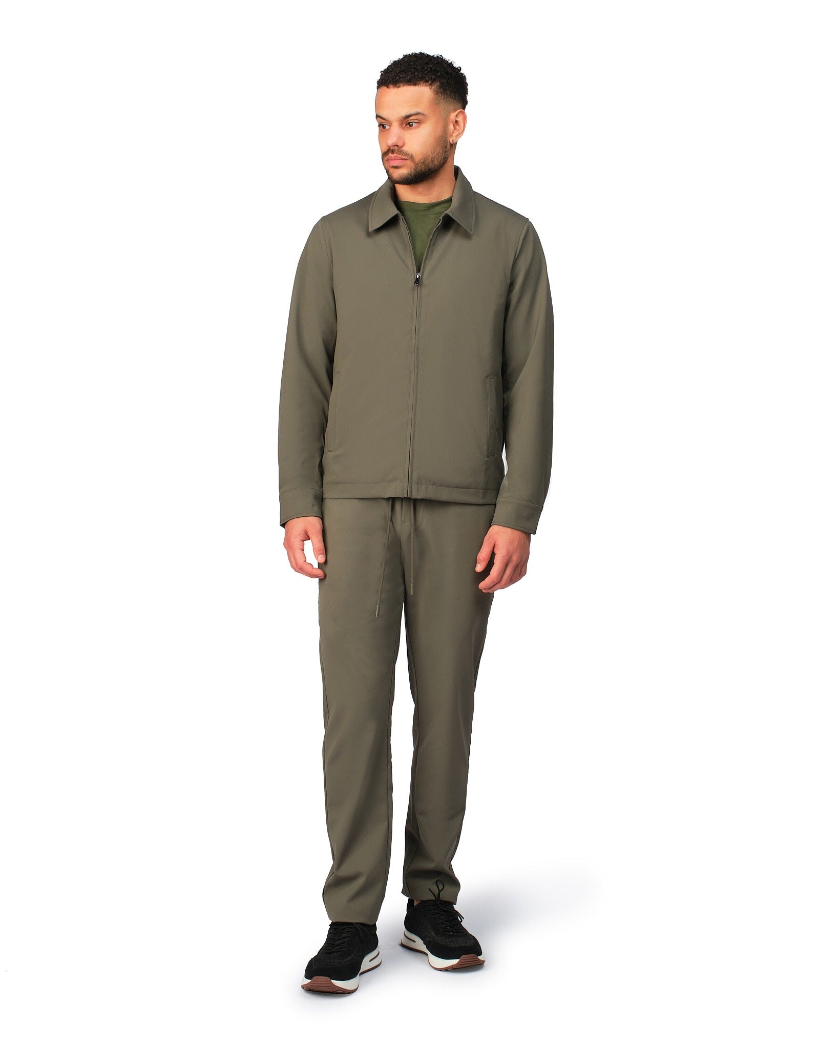 Green tech jacket with modern design and front zipper, detailed product view.