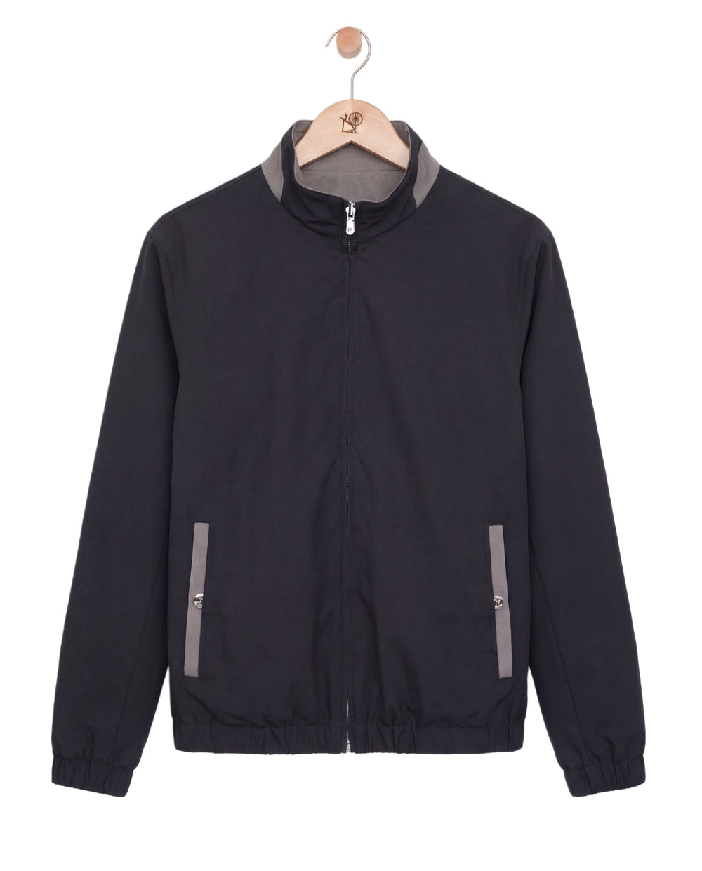 Black jacket with gray accents on a hanger against a white background
