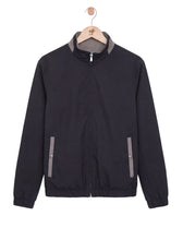 Black jacket with gray accents on a hanger against a white background