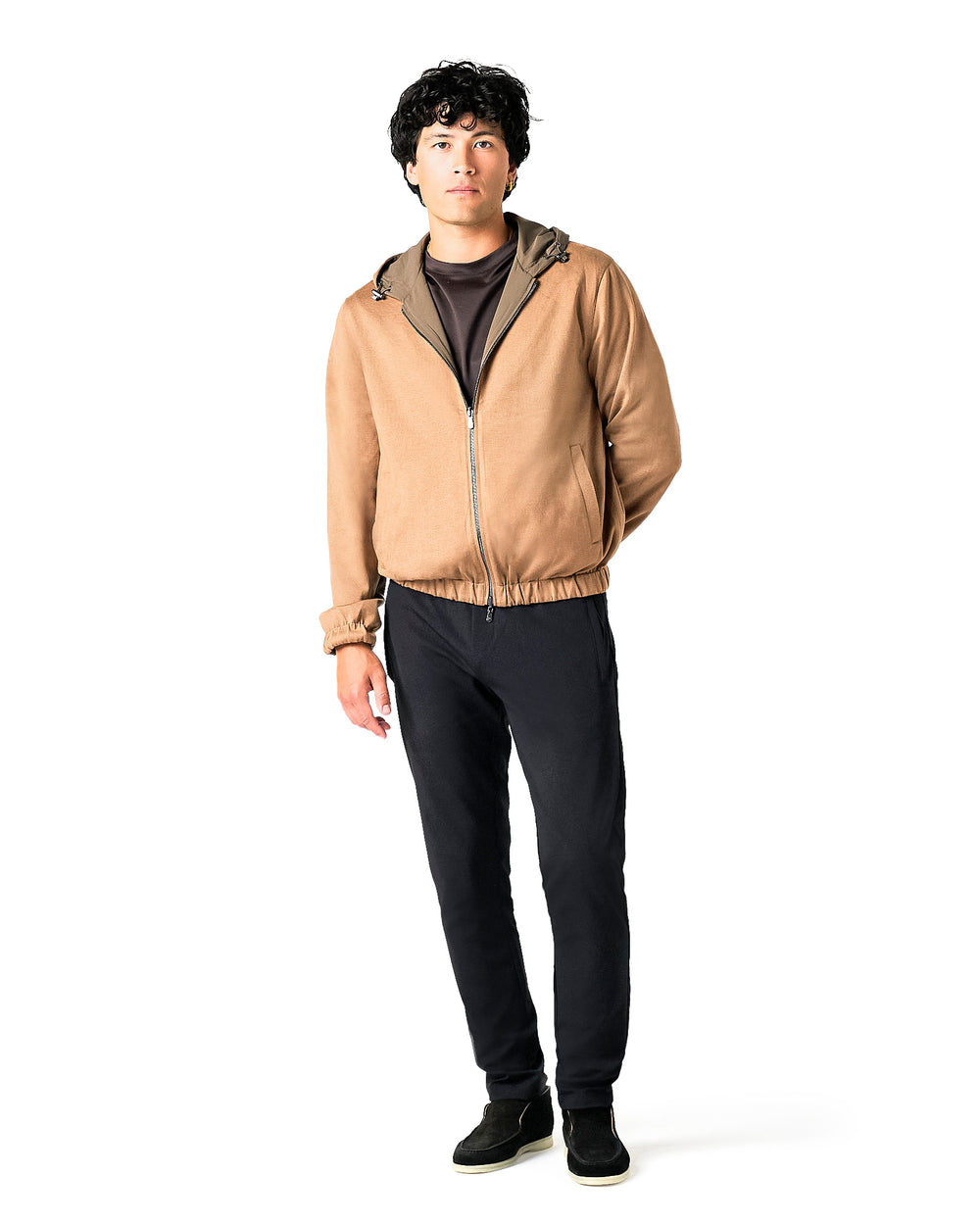 Person wearing a tan jacket with a hood on a white background