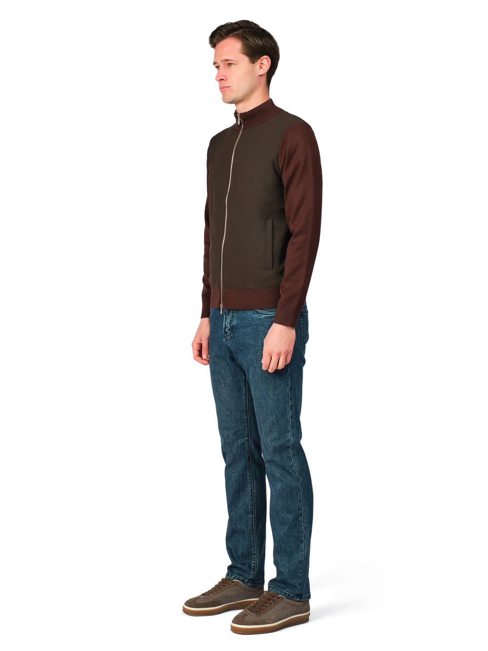 Man wearing a brown jacket and blue jeans on a white background