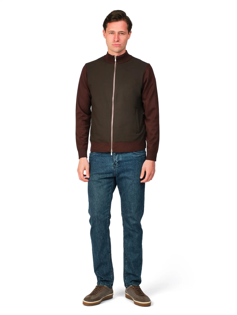Man wearing a brown jacket and blue jeans on a white background