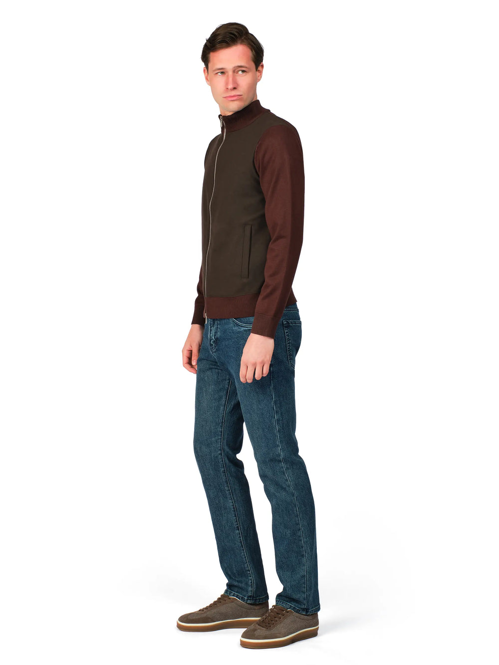 Man wearing a brown jacket and blue jeans on a white background