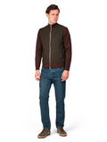 Man wearing a brown jacket and blue jeans on a white background