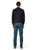 Man wearing a black sweater and blue jeans on a white background