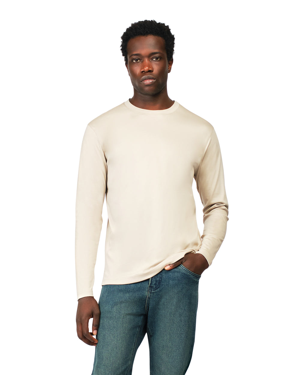 Man wearing a beige long-sleeve shirt and blue jeans on a white background