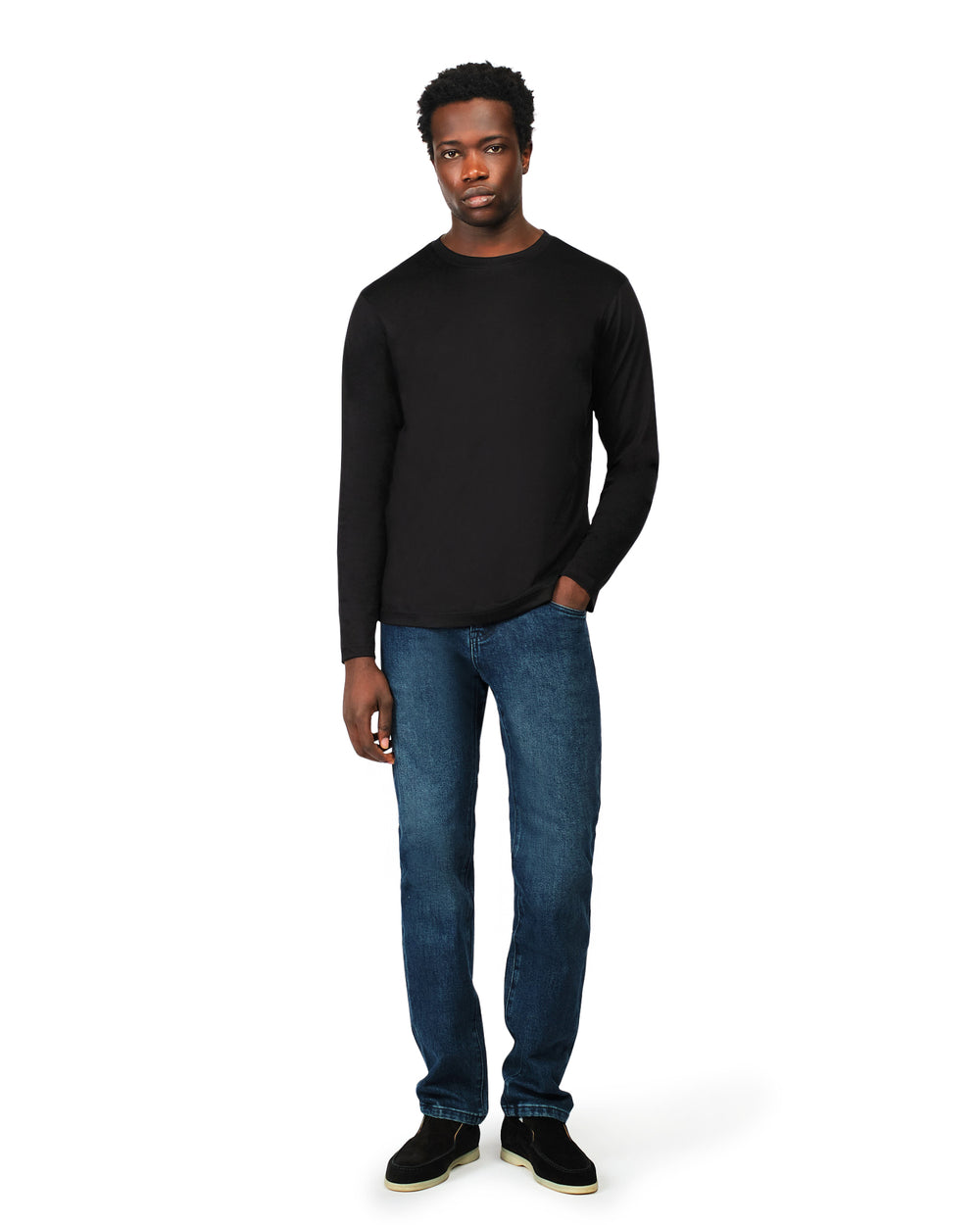 Man wearing a black long-sleeve shirt and blue jeans on a white background