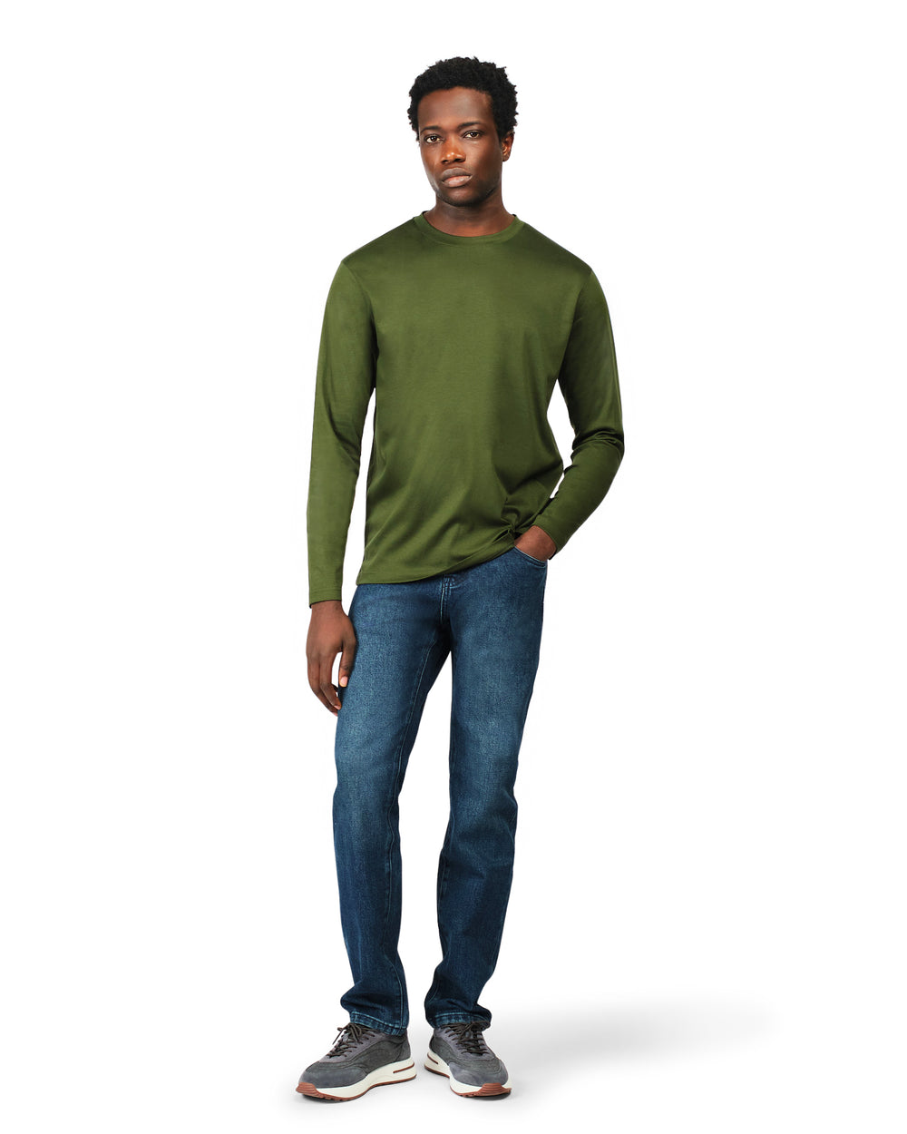 Man wearing a green long-sleeve shirt and blue jeans on a white background