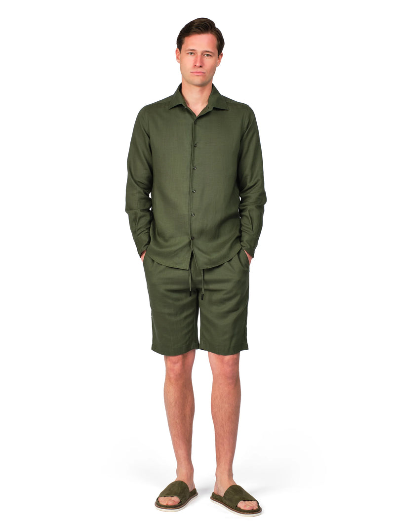 Man wearing a green jumpsuit on a white background