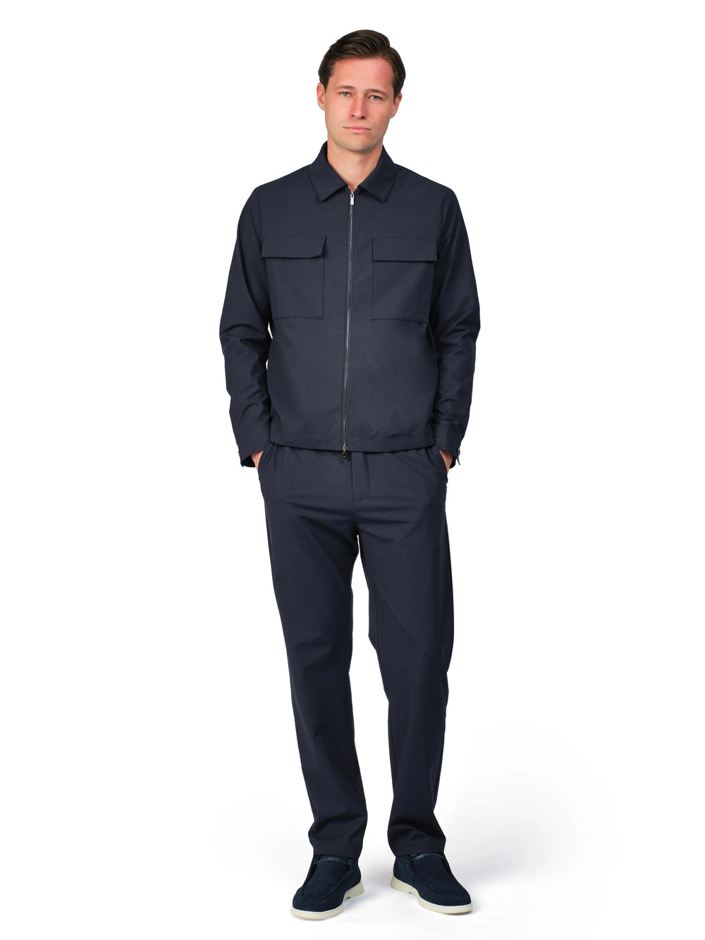 Man wearing a navy blue jumpsuit on a white background