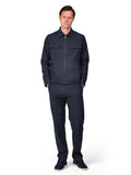 Man wearing a navy blue jumpsuit on a white background