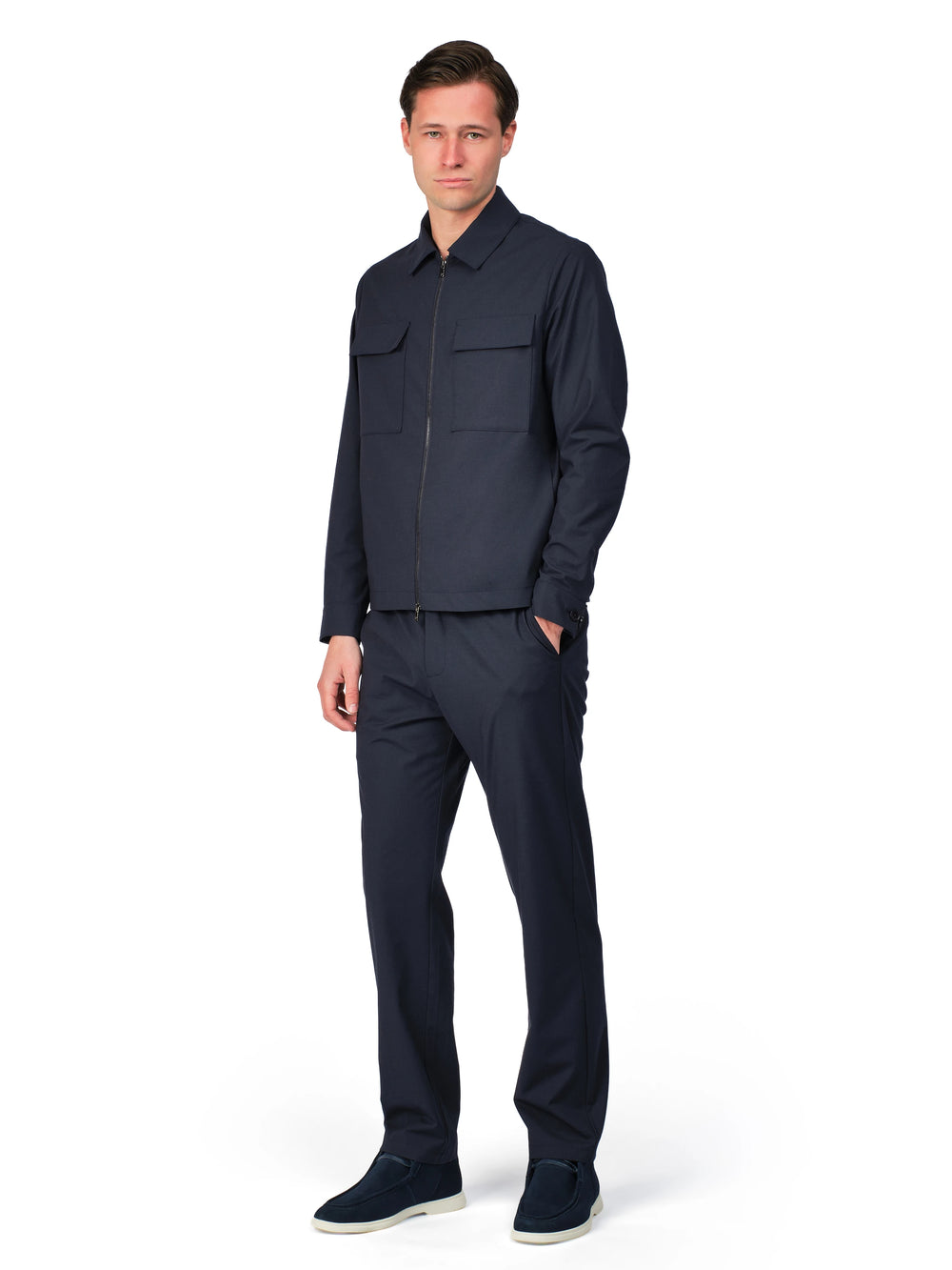 Man wearing a dark blue outfit on a white background
