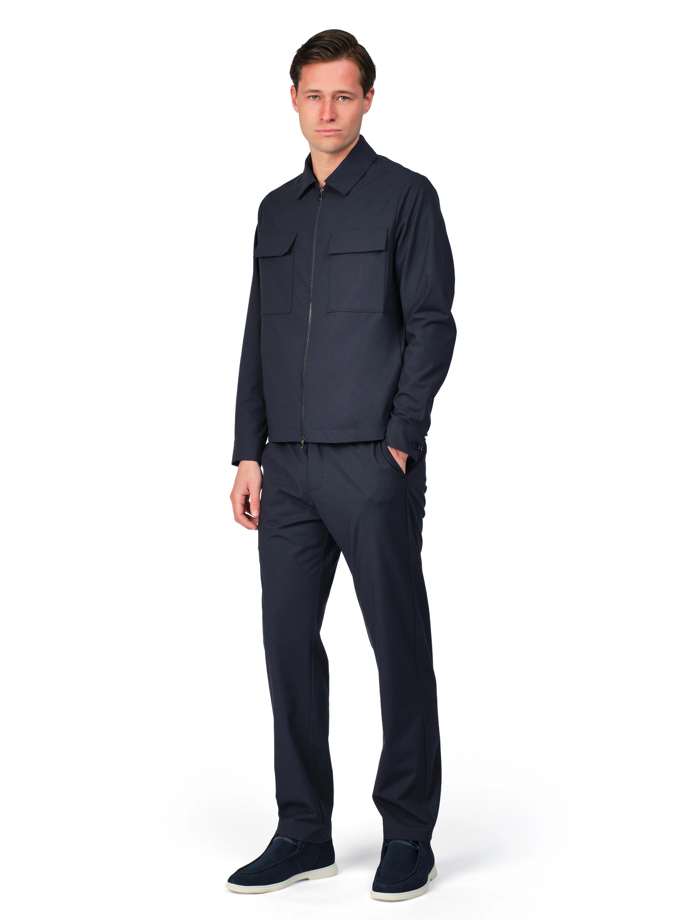 Man wearing a dark blue outfit on a white background
