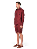 Man wearing a maroon hoodie and shorts on a white background