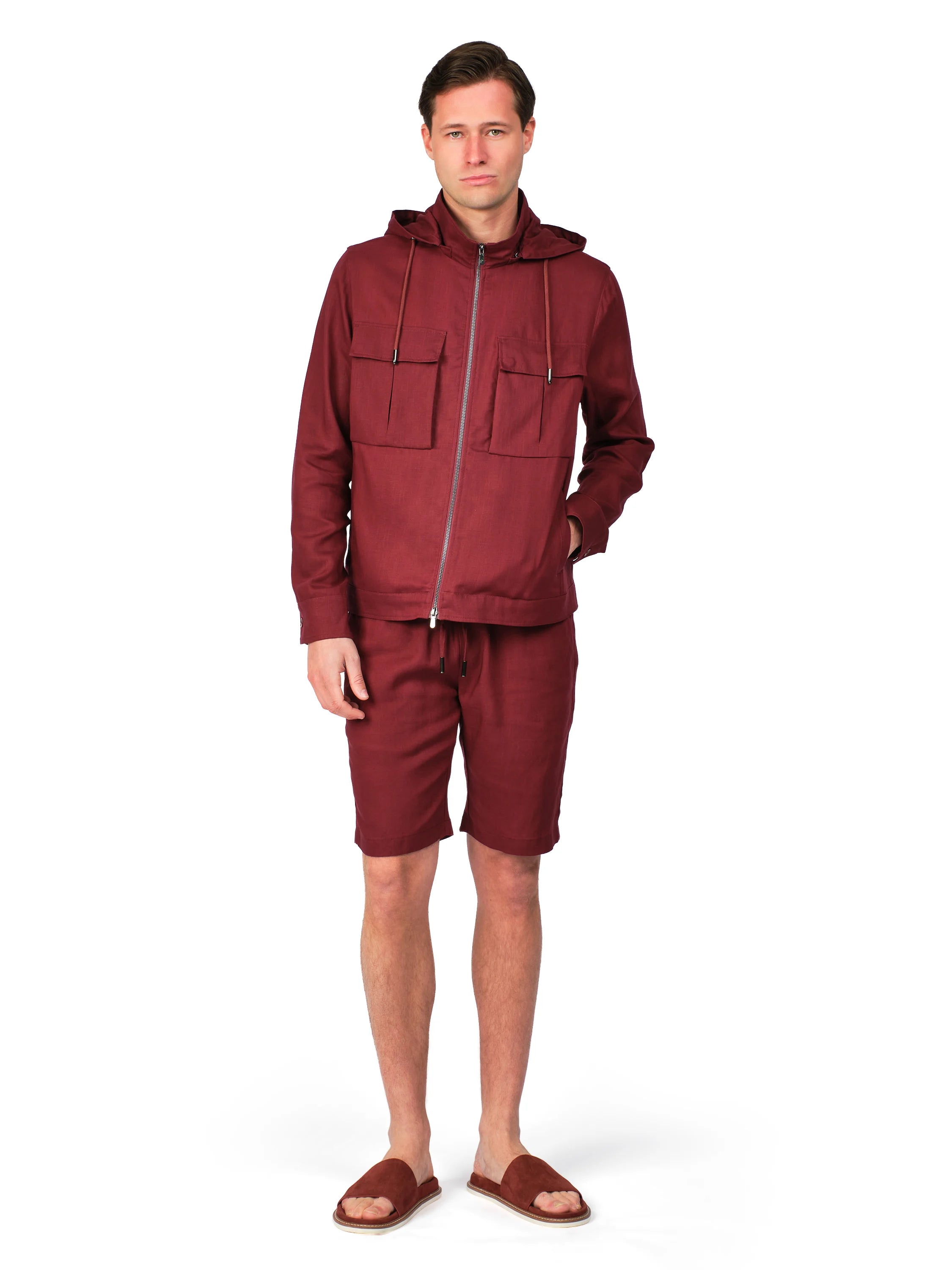 Man wearing a maroon tracksuit on a white background