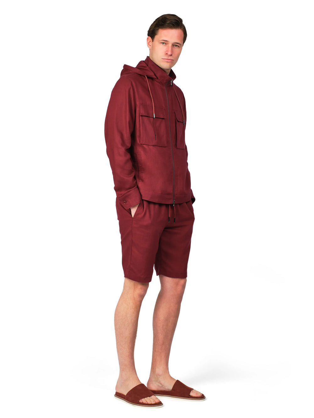 Man wearing a maroon tracksuit on a white background