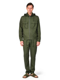 Man wearing a green jacket and pants on a white background
