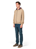 Man wearing a beige jacket with a maroon hood and blue jeans on a white background