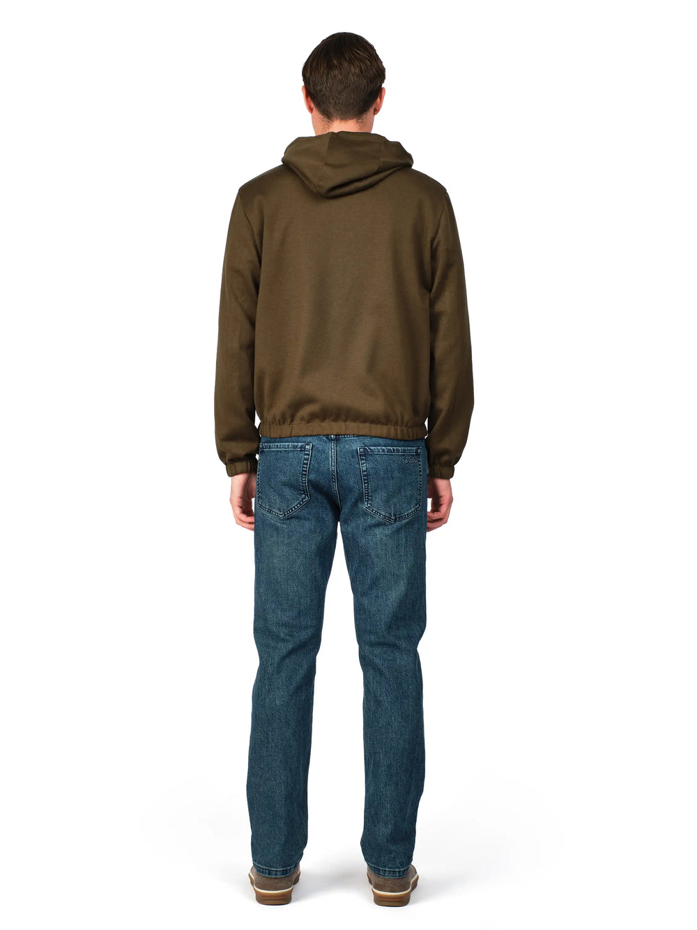 Man wearing a brown hoodie and blue jeans on a white background