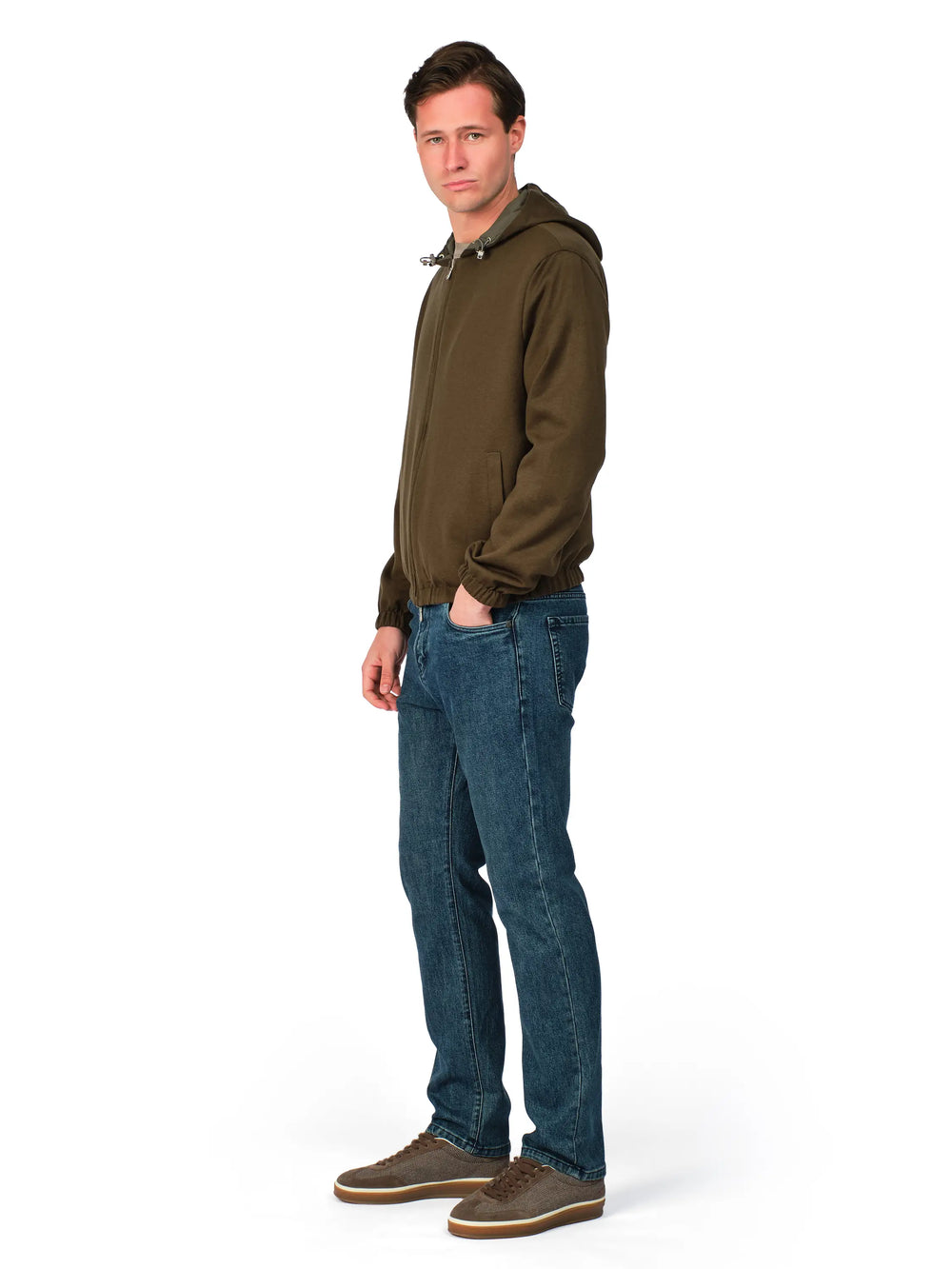 Man wearing a brown jacket and blue jeans on a white background