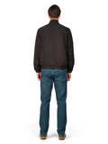 Man wearing a black jacket and blue jeans on a white background
