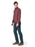 Man wearing a maroon sweater and blue jeans on a white background